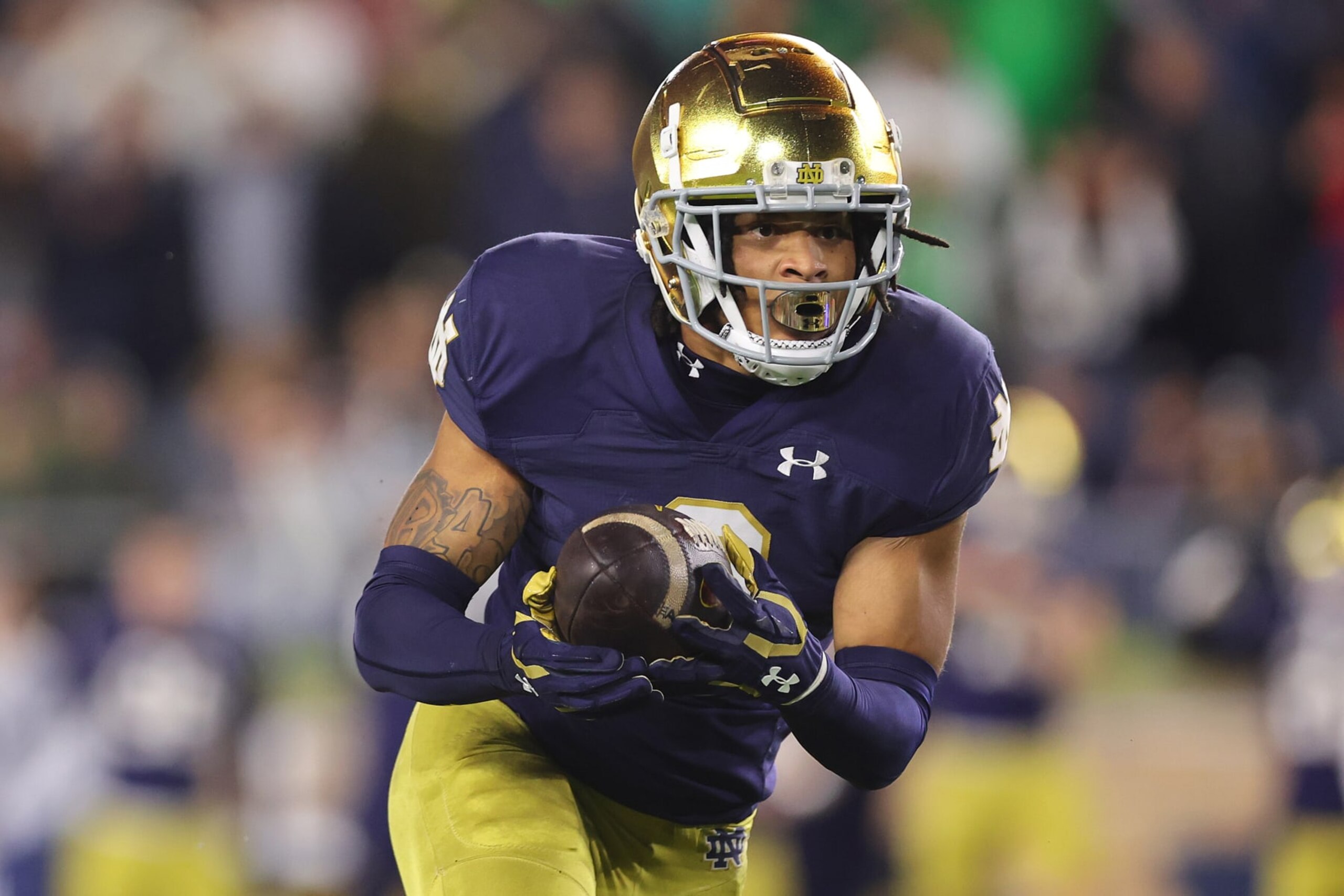 SOUTH BEND, INDIANA - OCTOBER 14: Xavier Watts #0 of the Notre Dame Fighting Irish intercepts a pass from Caleb Williams #13 of the USC Trojans during the first half at Notre Dame Stadium on October 14, 2023 in South Bend, Indiana. (Photo by Michael Reaves/Getty Images)