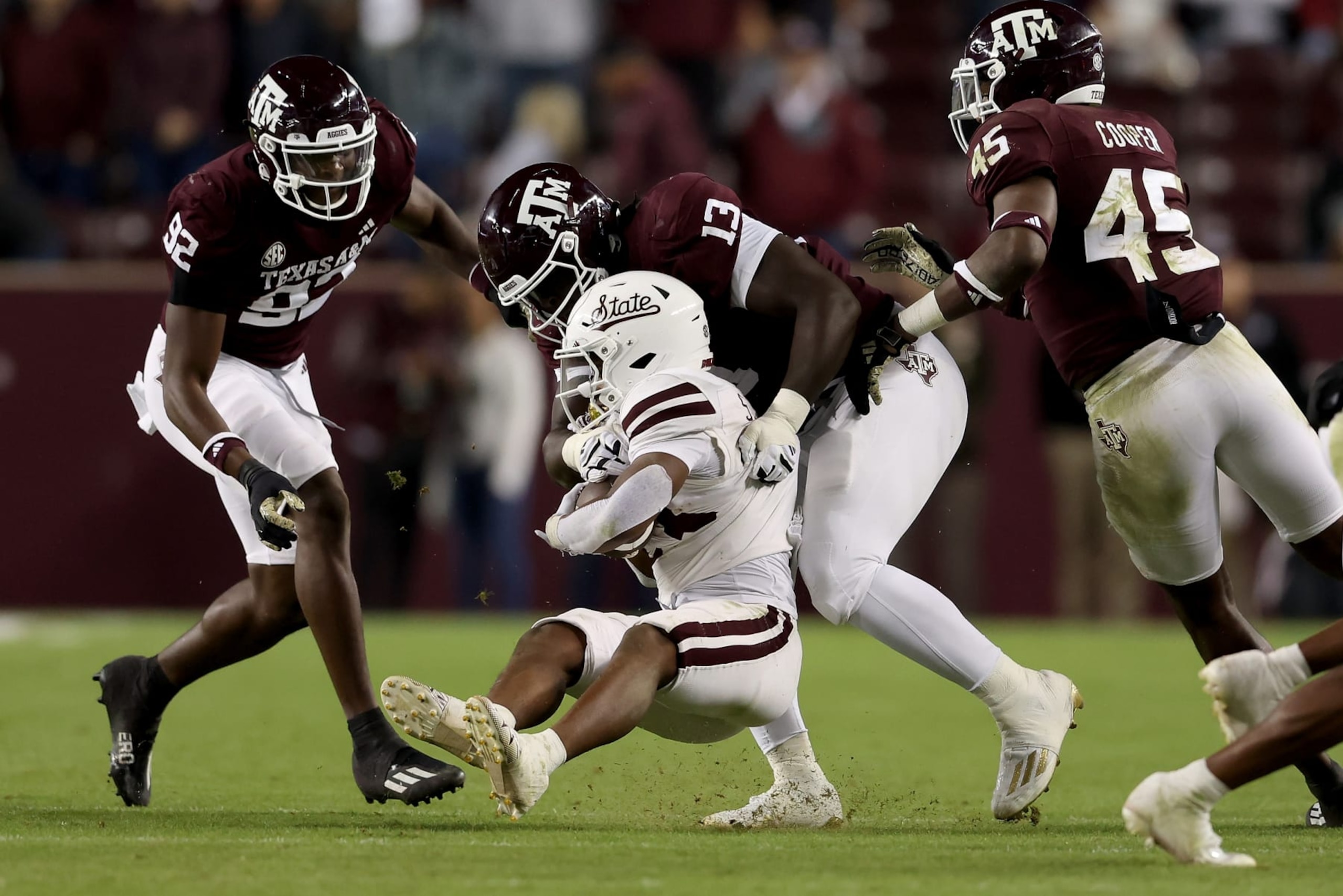 COLLEGE STATION, TEXAS - NOVEMBER 11: DJ Hicks #13 of the Texas A&M Aggies tackles Seth Davis #23 of the Mississippi State Bulldogs in the second half at Kyle Field on November 11, 2023 in College Station, Texas. (Photo by Tim Warner/Getty Images)