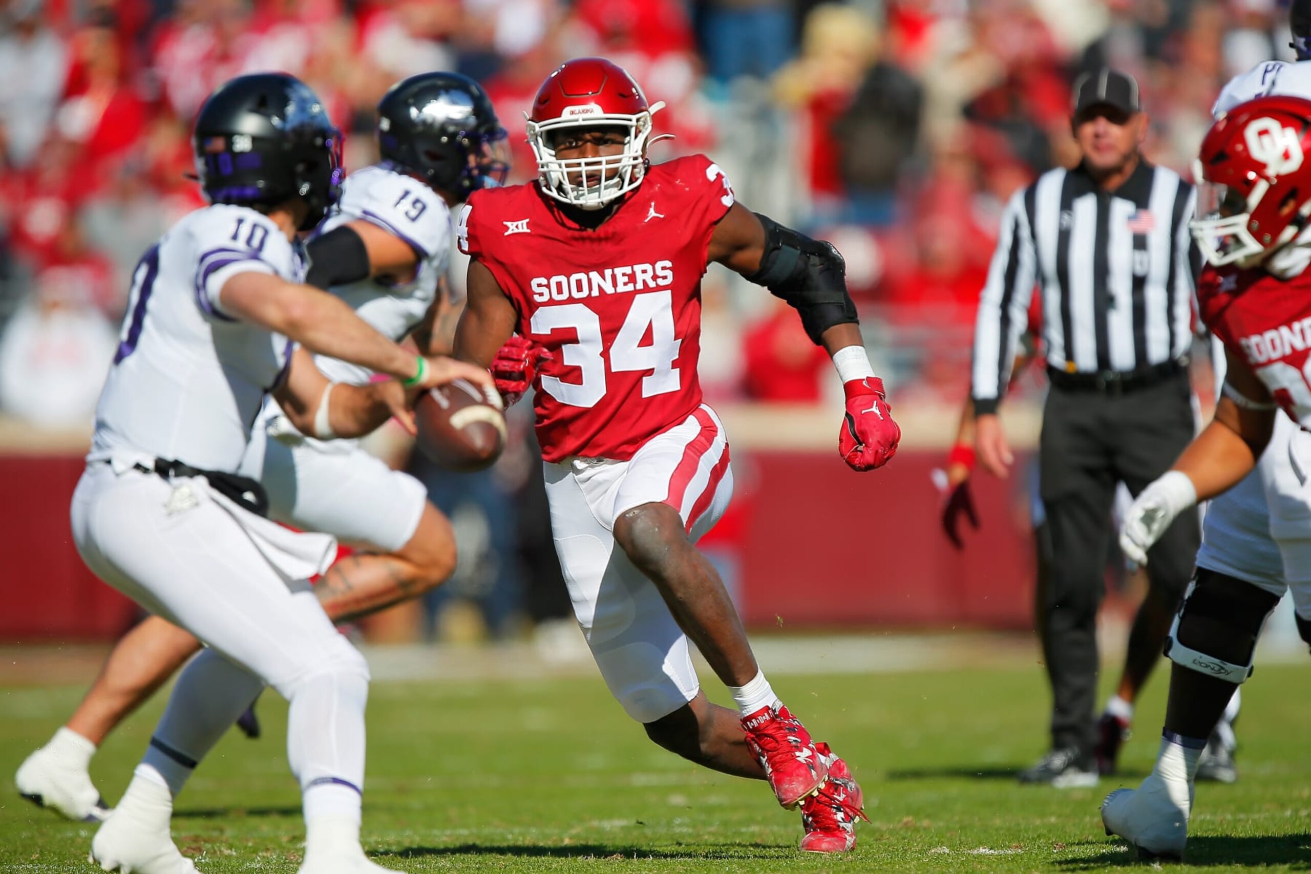 NORMAN, OKLAHOMA - NOVEMBER 24:  Defensive lineman Adepoju Adebawore #34 of the Oklahoma Sooners rushes quarterback Josh Hoover #10 of the TCU Horned Frogs in the first quarter at Gaylord Family Oklahoma Memorial Stadium on November 24, 2023 in Norman, Oklahoma.  Oklahoma won 69-45. (Photo by Brian Bahr/Getty Images)