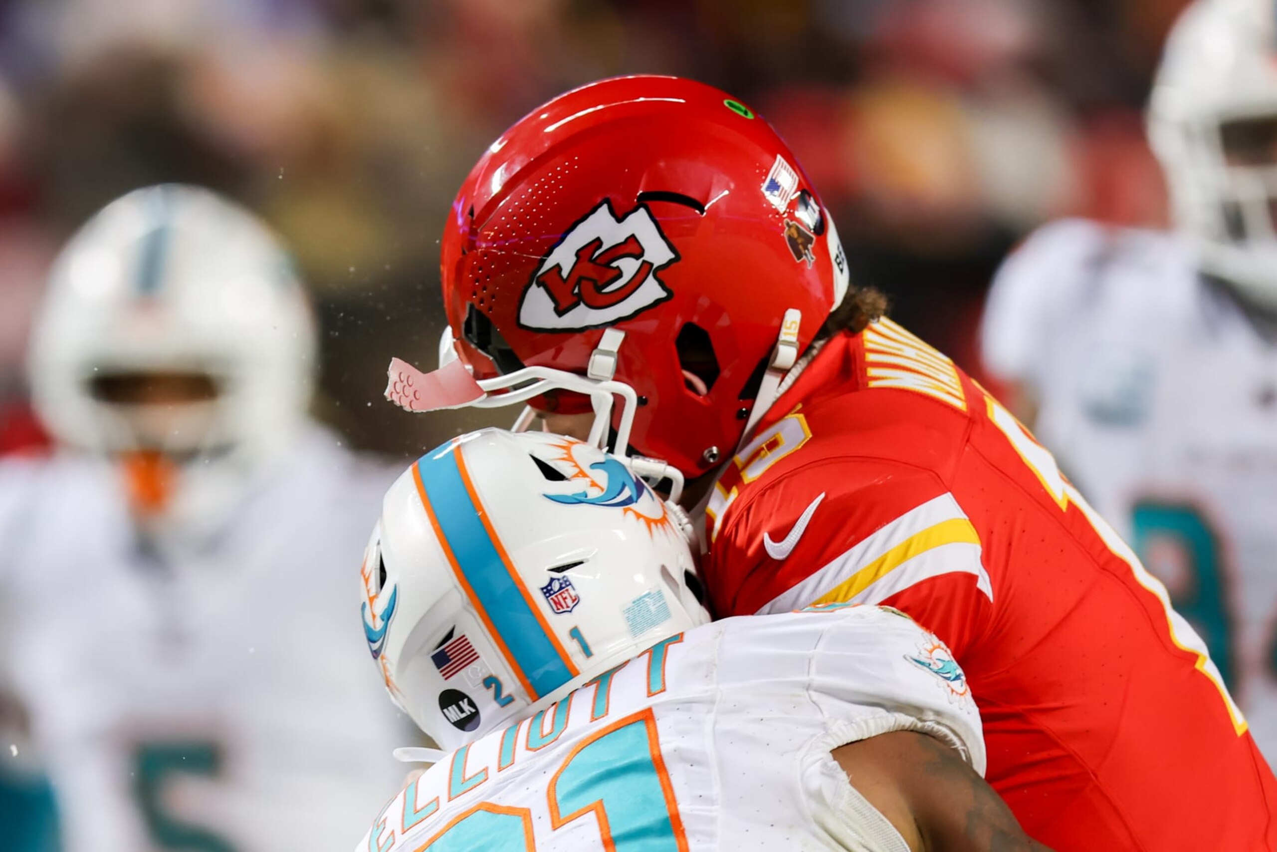 KANSAS CITY, MO - JANUARY 13: Kansas City Chiefs quarterback Patrick Mahomes (15) helmet cracks taking a hit from Miami Dolphins safety DeShon Elliott (21) in the third quarter of an AFC Wild Card playoff game between the Miami Dolphins and Kansas City Chiefs on Jan 13, 2024 at GEHA Field at Arrowhead Stadium in Kansas City, MO. (Photo by Scott Winters/Icon Sportswire via Getty Images)