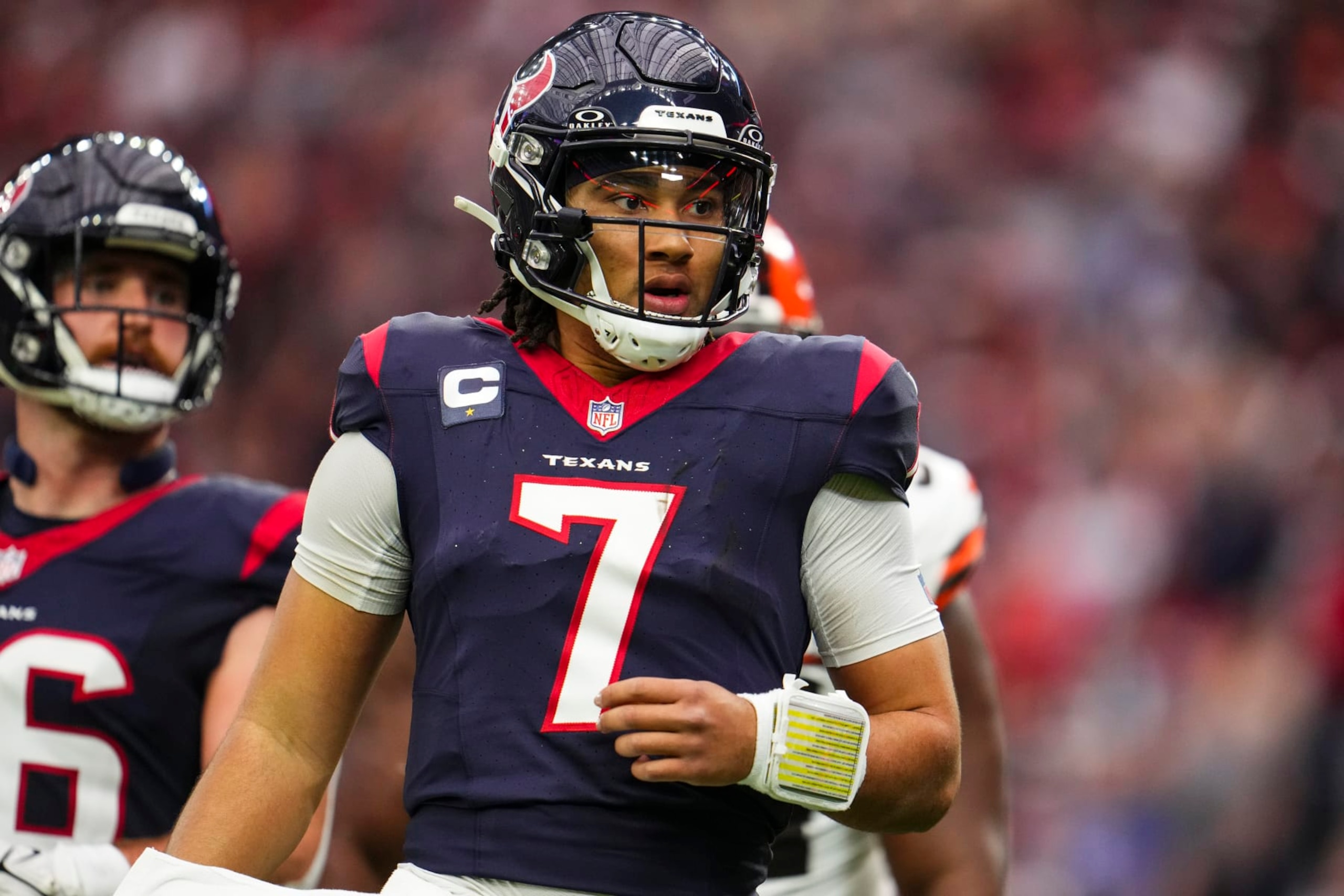 HOUSTON, TX - JANUARY 13: C.J. Stroud #7 of the Houston Texans looks on from the field during an NFL wild-card playoff football game against the Cleveland Browns at NRG Stadium on January 13, 2024 in Houston, Texas. (Photo by Cooper Neill/Getty Images)