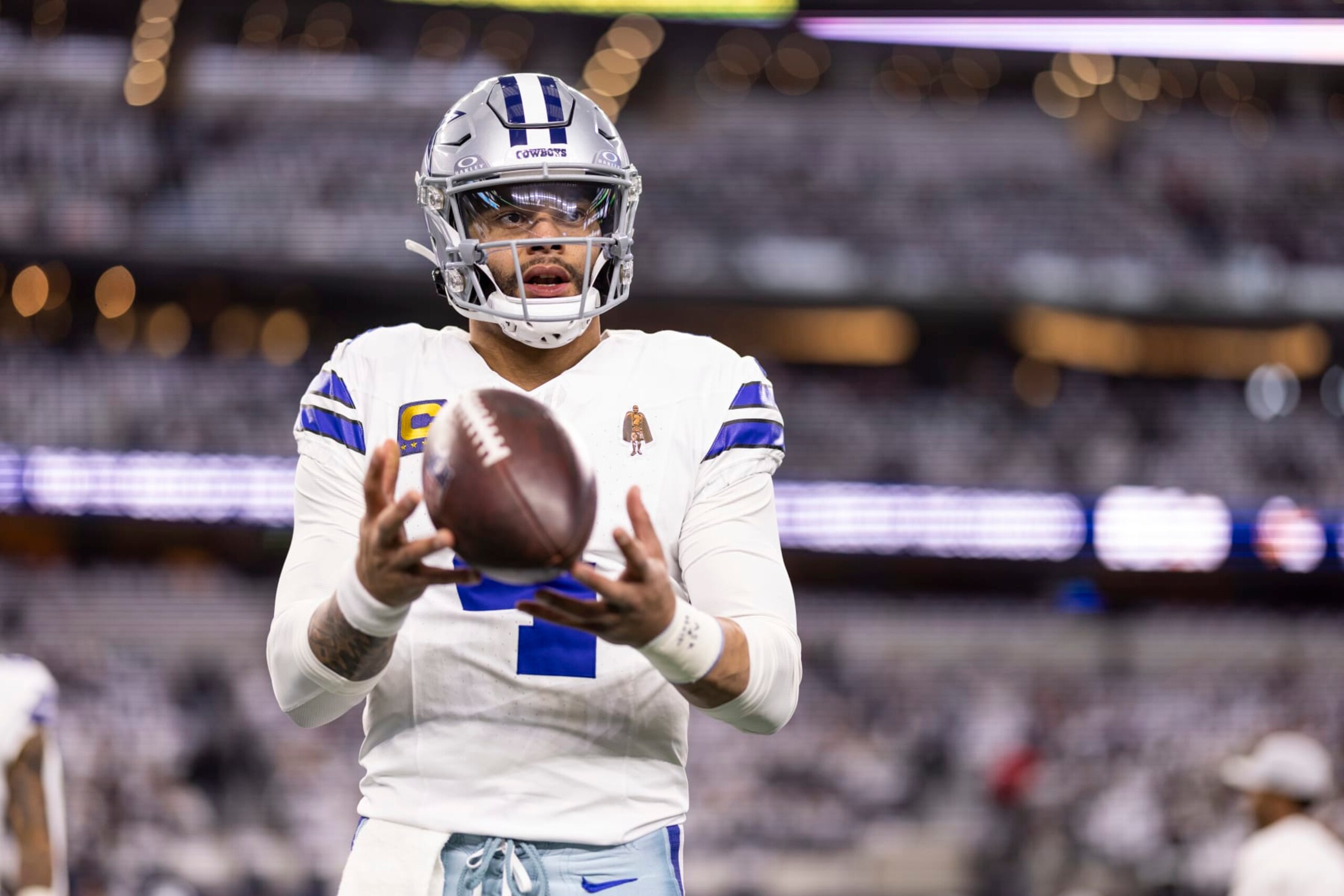 ARLINGTON, TEXAS - JANUARY 14: Dak Prescott #4 of the Dallas Cowboys looks to pass as he warms up prior to an NFL wild-card playoff football game between the Dallas Cowboys and the Green Bay Packers at AT&T Stadium on January 14, 2024 in Arlington, Texas. (Photo by Michael Owens/Getty Images)