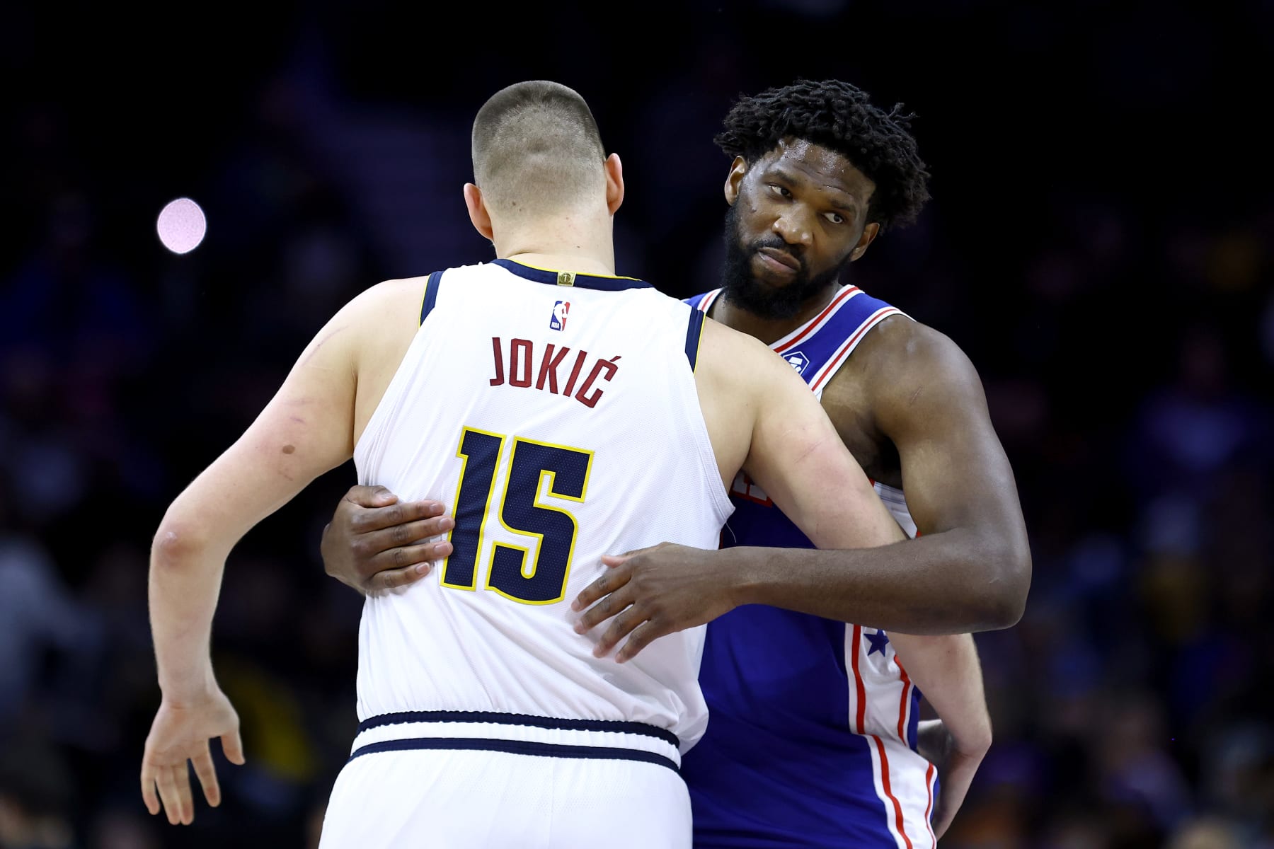 PHILADELPHIA, PENNSYLVANIA - JANUARY 16: Nikola Jokic #15 of the Denver Nuggets and Joel Embiid #21 of the Philadelphia 76ers embrace before playing  at the Wells Fargo Center on January 16, 2024 in Philadelphia, Pennsylvania. NOTE TO USER: User expressly acknowledges and agrees that, by downloading and or using this photograph, User is consenting to the terms and conditions of the Getty Images License Agreement. (Photo by Tim Nwachukwu/Getty Images)
