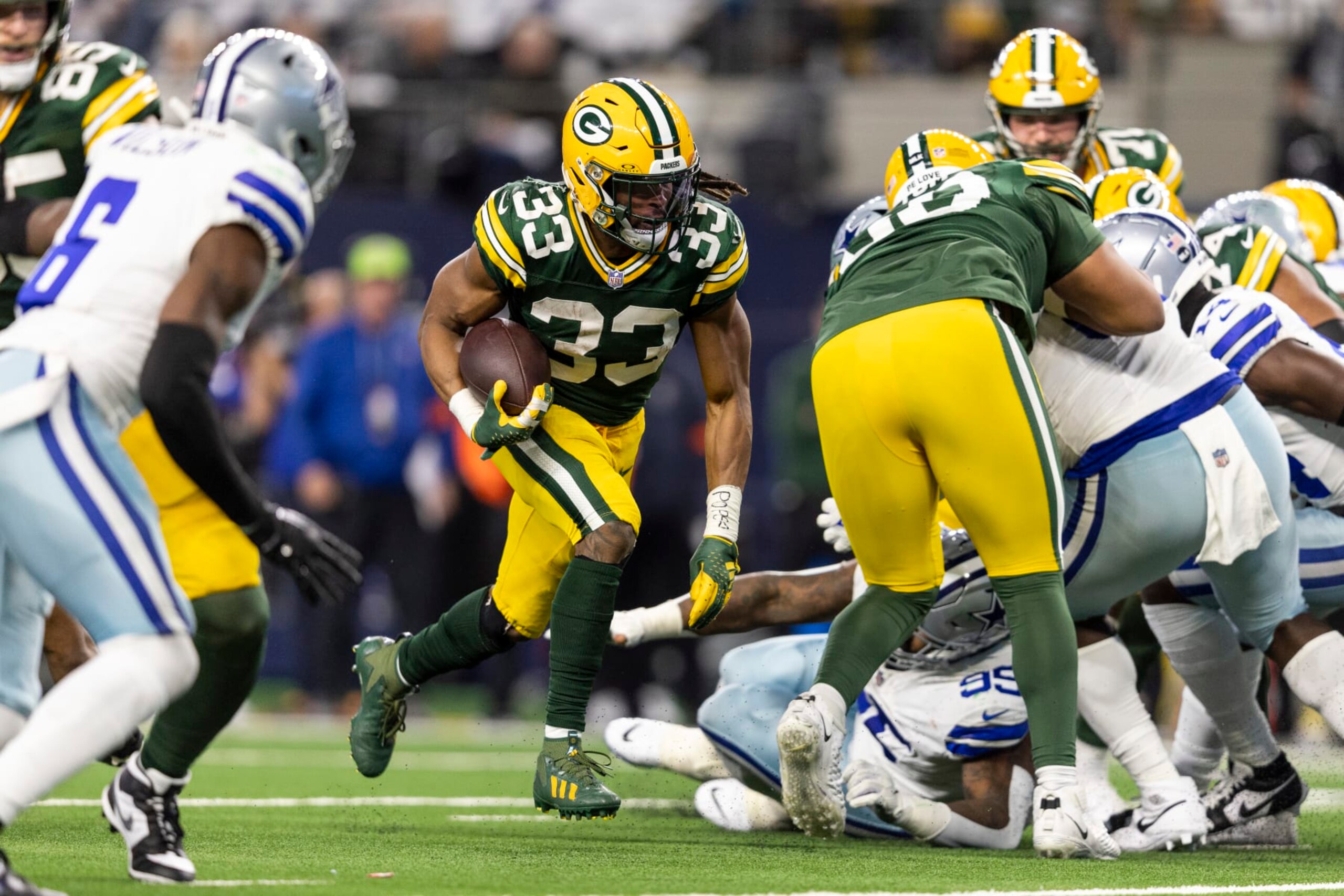 ARLINGTON, TEXAS - JANUARY 14: Aaron Jones #33 of the Green Bay Packers runs with the ball for a touchdown during an NFL wild-card playoff football game between the Dallas Cowboys and the Green Bay Packers at AT&T Stadium on January 14, 2024 in Arlington, Texas. (Photo by Michael Owens/Getty Images)