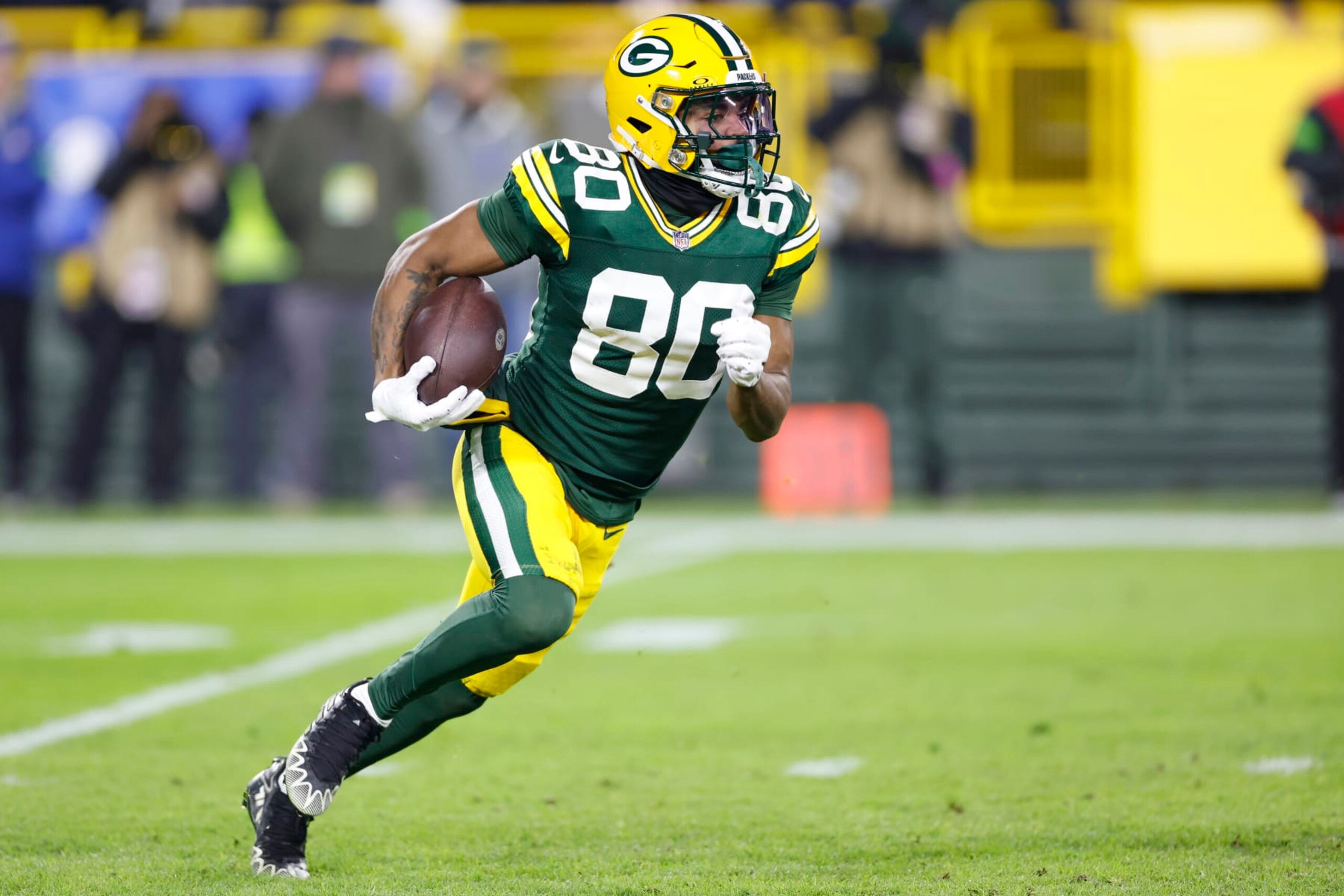 GREEN BAY, WISCONSIN - JANUARY 07: Bo Melton #80 of the Green Bay Packers runs the ball during the third quarter in the game against the Chicago Bears at Lambeau Field on January 07, 2024 in Green Bay, Wisconsin. (Photo by John Fisher/Getty Images)