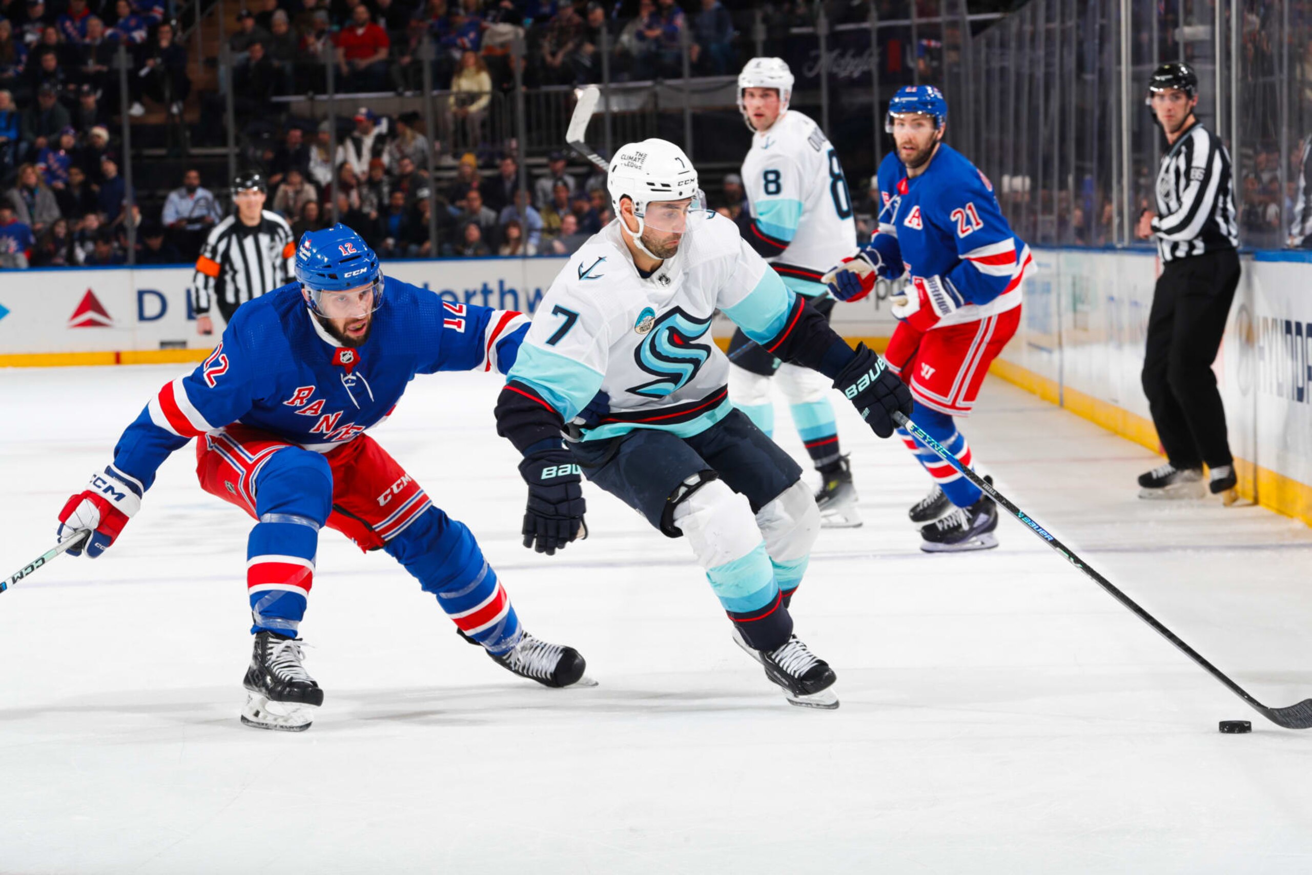 NEW YORK, NEW YORK - JANUARY 16:  Jordan Eberle #7 of the Seattle Kraken skates with the puck against Nick Bonino #12 of the New York Rangers at Madison Square Garden on January 16, 2024 in New York City. (Photo by Jared Silber/NHLI via Getty Images)