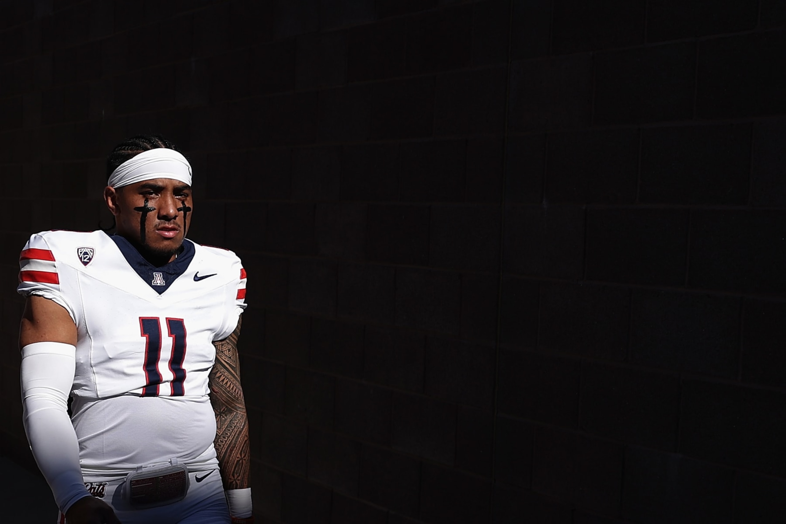 TEMPE, ARIZONA - NOVEMBER 25: Quarterback Noah Fifita #11 of the Arizona Wildcats walks out to the field before the NCAAF game against the Arizona State Sun Devils at Mountain America Stadium on November 25, 2023 in Tempe, Arizona. (Photo by Christian Petersen/Getty Images)