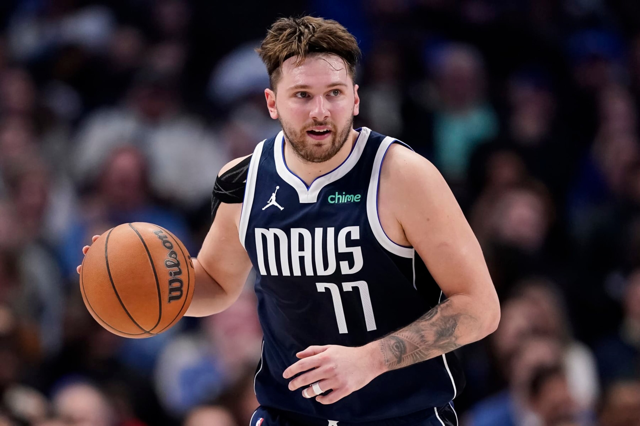 DALLAS, TEXAS - JANUARY 03: Luka Doncic #77 of the Dallas Mavericks brings the ball down court during the second half against the Portland Trail Blazers at American Airlines Center on January 03, 2024 in Dallas, Texas. NOTE TO USER: User expressly acknowledges and agrees that, by downloading and or using this photograph, User is consenting to the terms and conditions of the Getty Images License Agreement. (Photo by Sam Hodde/Getty Images)