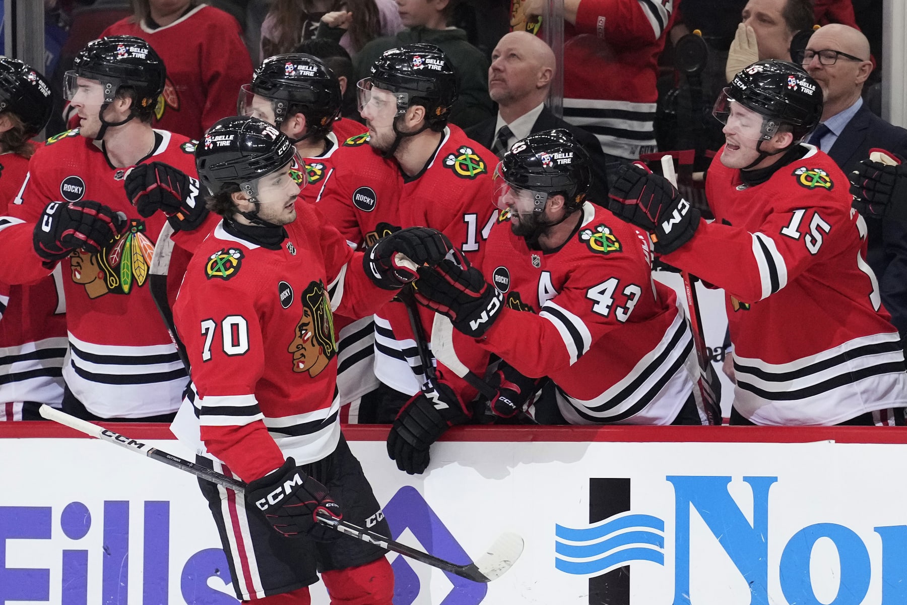 CHICAGO, ILLINOIS - JANUARY 16: Cole Guttman #70 of the Chicago Blackhawks celebrates scoring with the bench during the first period against the San Jose Sharks at the United Center on January 16, 2024 in Chicago, Illinois. (Photo by Patrick McDermott/Getty Images)