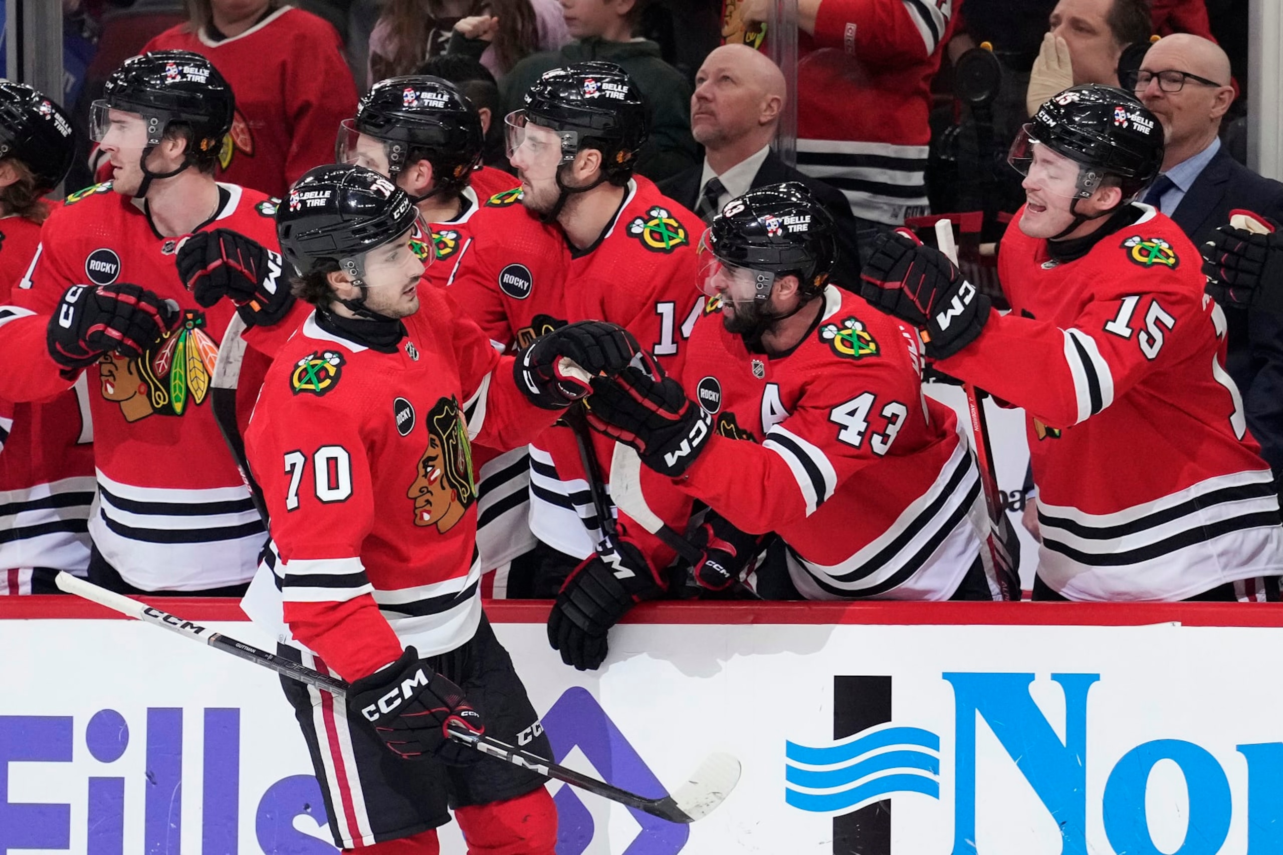 CHICAGO, ILLINOIS - JANUARY 16: Cole Guttman #70 of the Chicago Blackhawks celebrates scoring with the bench during the first period against the San Jose Sharks at the United Center on January 16, 2024 in Chicago, Illinois. (Photo by Patrick McDermott/Getty Images)