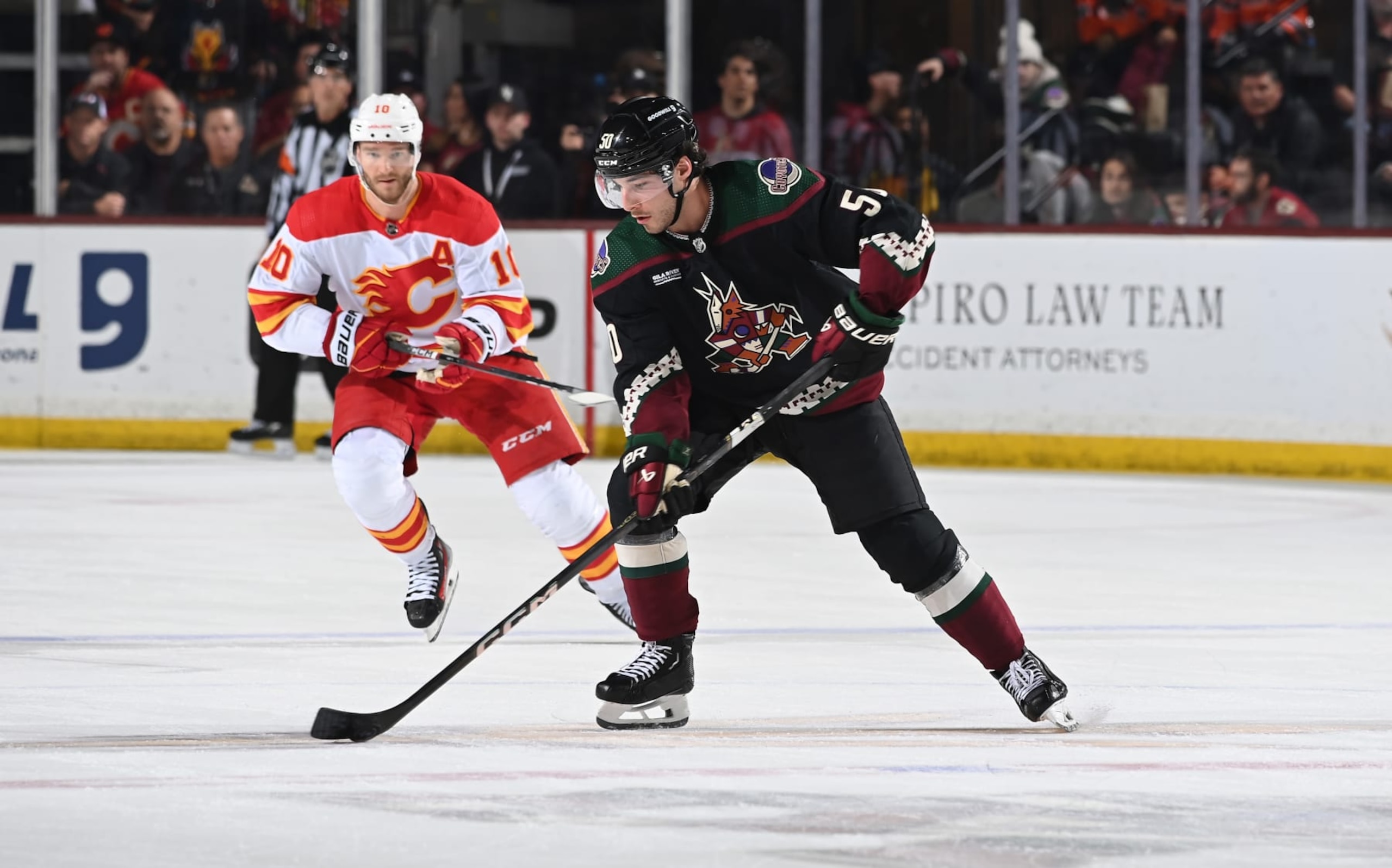 TEMPE, ARIZONA - JANUARY 11: Sean Durzi #50 of the Arizona Coyotes skates with the puck against the Calgary Flames at Mullett Arena on January 11, 2024 in Tempe, Arizona. (Photo by Norm Hall/NHLI via Getty Images)