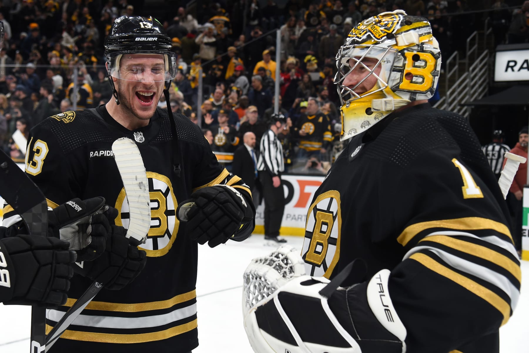 BOSTON, MASSACHUSETTS - JANUARY 15: Charlie Coyle #13 and Jeremy Swayman #1 of the Boston Bruins celebrate the win against the New Jersey Devils at the TD Garden on January 15, 2024 in Boston, Massachusetts. (Photo by Steve Babineau/NHLI via Getty Images)