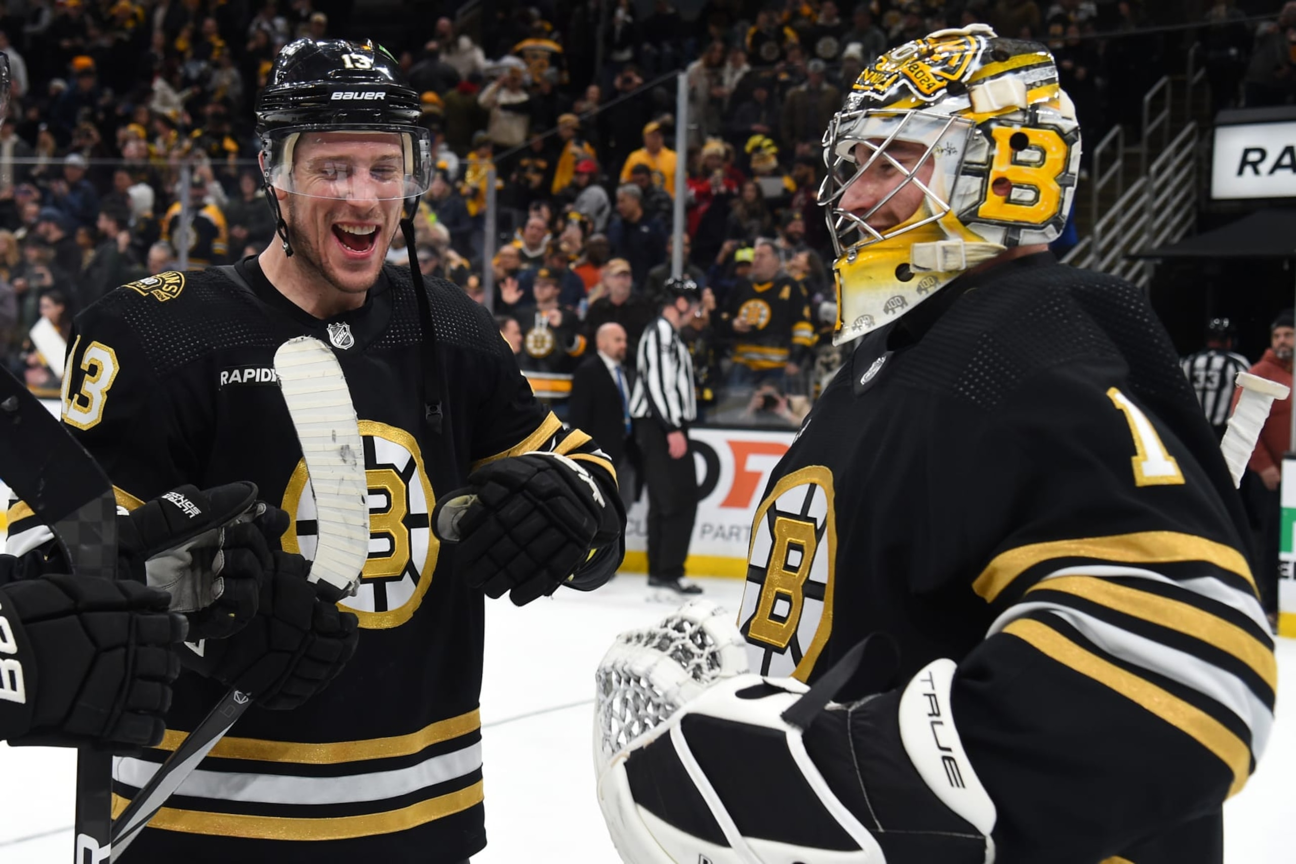 BOSTON, MASSACHUSETTS - JANUARY 15: Charlie Coyle #13 and Jeremy Swayman #1 of the Boston Bruins celebrate the win against the New Jersey Devils at the TD Garden on January 15, 2024 in Boston, Massachusetts. (Photo by Steve Babineau/NHLI via Getty Images)