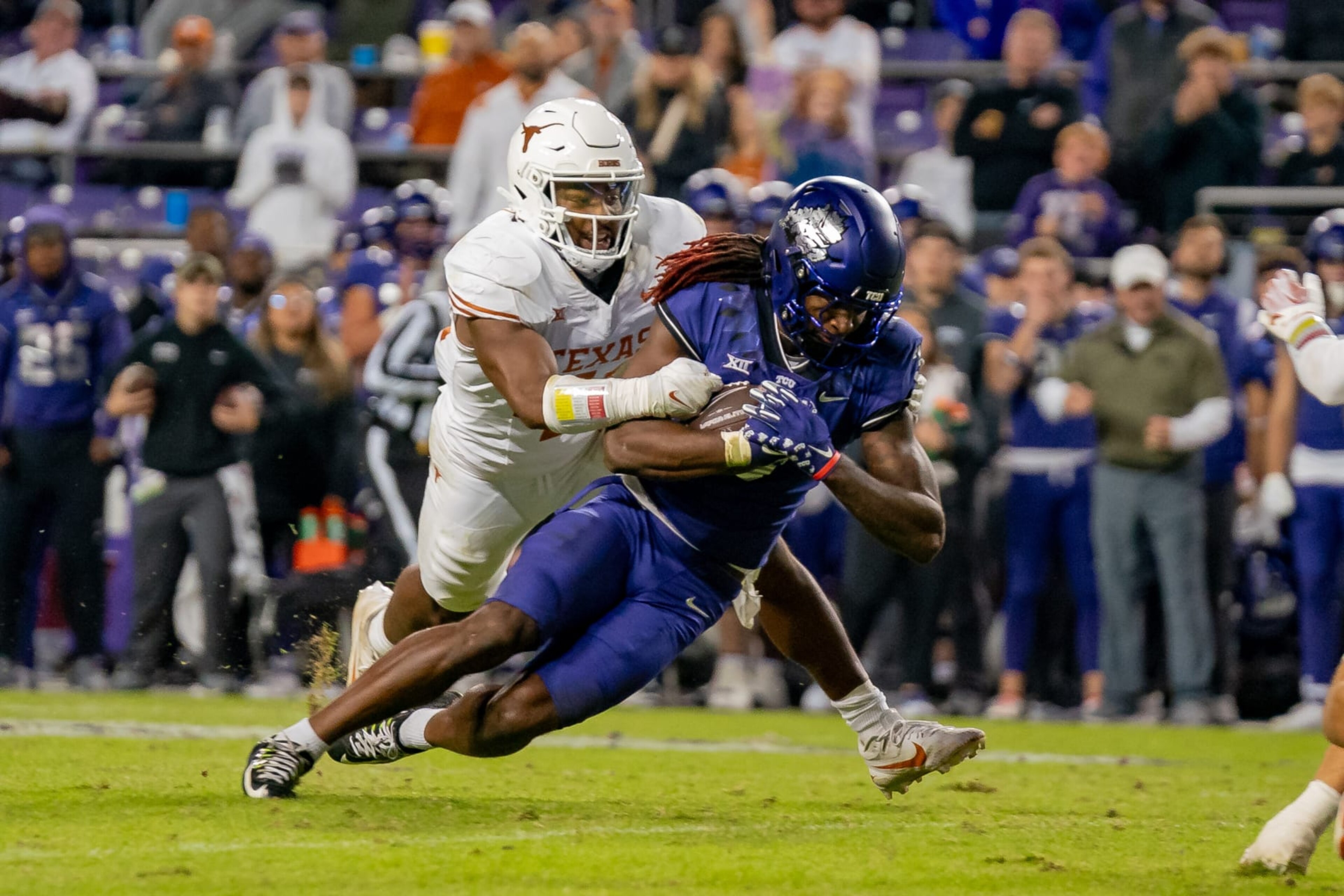 FORT WORTH, TX - NOVEMBER 11: TCU Horned Frogs wide receiver Savion Williams (3) is tackled by Texas Longhorns linebacker Jaylan Ford (41) during a game between the Texas Longhorns and TCU Horned Frogs college football game on November 11, 2023 at Amon G. Carter Stadium in Fort Worth, TX. (Photo by Chris Leduc/Icon Sportswire via Getty Images) FORT WORTH, TX - NOVEMBER 11: TCU Horned Frogs wide receiver Savion Williams (3) is tackled by Texas Longhorns linebacker Jaylan Ford (41) during a game between the Texas Longhorns and TCU Horned Frogs college football game on November 11, 2023 at Amon G. Carter Stadium in Fort Worth, TX. (Photo by Chris Leduc/Icon Sportswire via Getty Images)