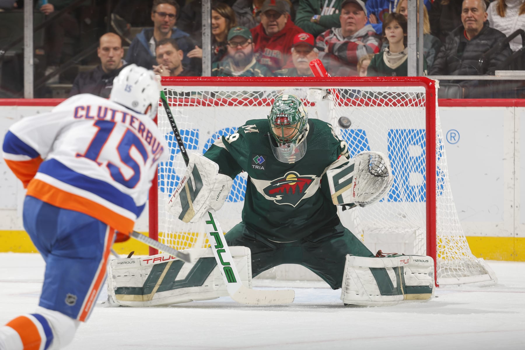 SAINT PAUL, MN - JANUARY 15: Marc-Andre Fleury #29 of the Minnesota Wild makes a save against Cal Clutterbuck #15 of the New York Islanders during the game at the Xcel Energy Center on January 15, 2024 in Saint Paul, Minnesota. (Photo by Bruce Kluckhohn/NHLI via Getty Images)