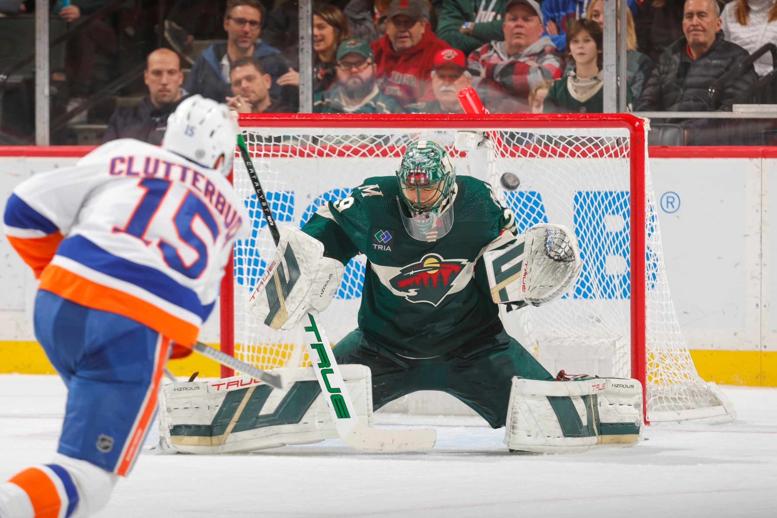 SAINT PAUL, MN - JANUARY 15: Marc-Andre Fleury #29 of the Minnesota Wild makes a save against Cal Clutterbuck #15 of the New York Islanders during the game at the Xcel Energy Center on January 15, 2024 in Saint Paul, Minnesota. (Photo by Bruce Kluckhohn/NHLI via Getty Images)