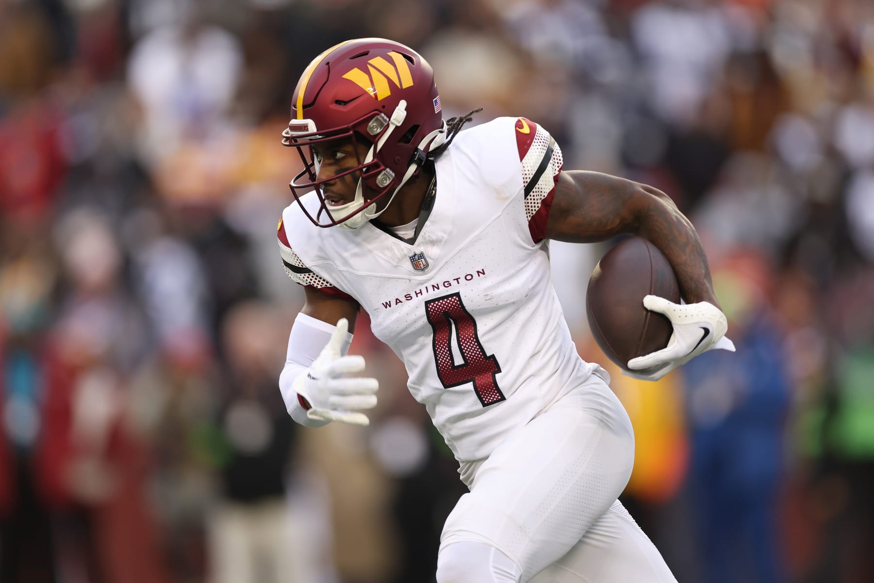 LANDOVER, MARYLAND - JANUARY 07: Curtis Samuel #4 of the Washington Commanders runs with the ball during the second quarter against the Dallas Cowboys at FedExField on January 07, 2024 in Landover, Maryland. (Photo by Patrick Smith/Getty Images)