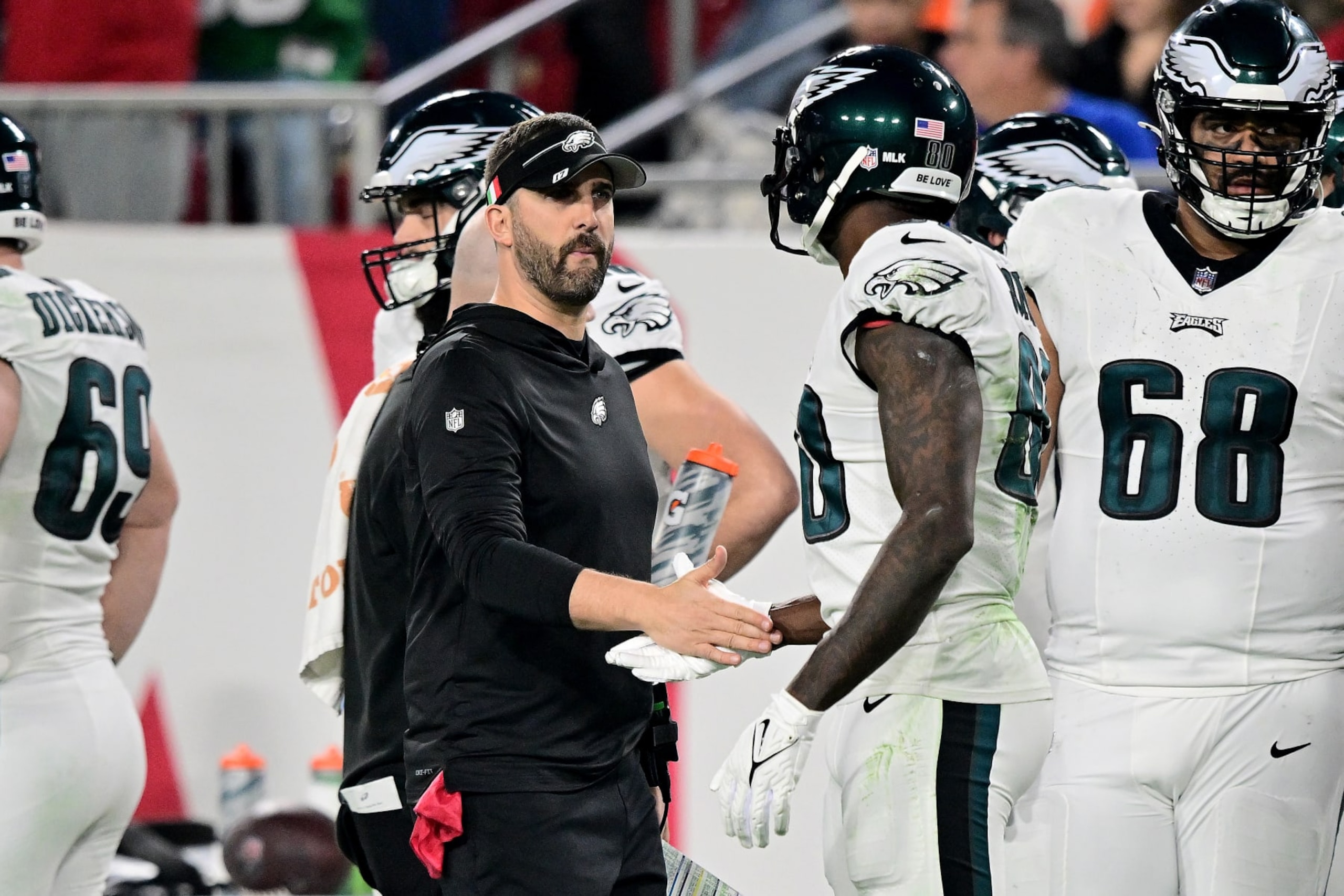 TAMPA, FLORIDA - JANUARY 15: Head coach Nick Sirianni of the Philadelphia Eagles high-fives Julio Jones #80 against the Tampa Bay Buccaneers during the second quarter in the NFC Wild Card Playoffs at Raymond James Stadium on January 15, 2024 in Tampa, Florida. (Photo by Julio Aguilar/Getty Images)