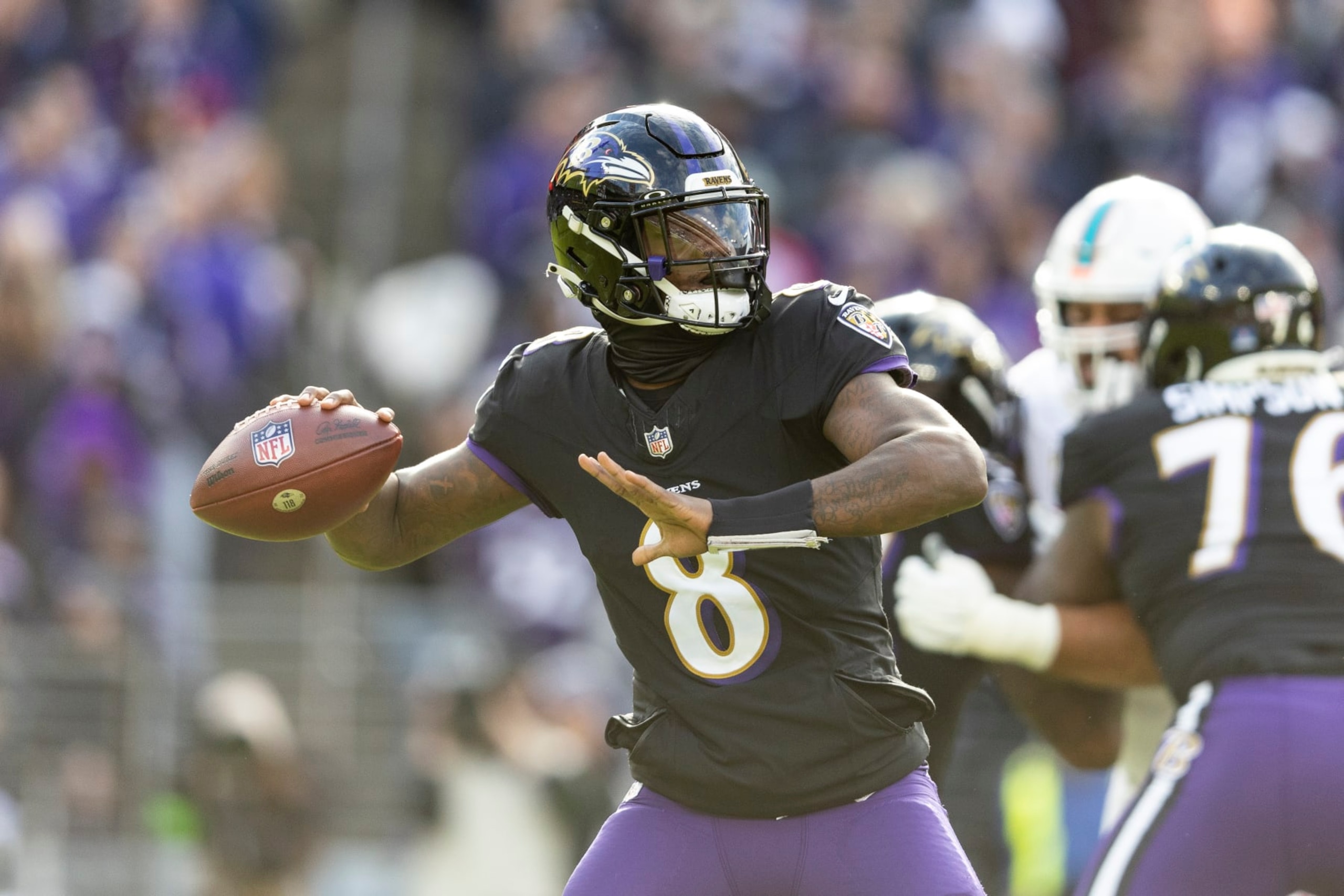 BALTIMORE, MARYLAND - DECEMBER 31: Lamar Jackson #8 of the Baltimore Ravens drops back and looks to pass during an NFL football game between the Baltimore Ravens and the Miami Dolphins at M&T Bank Stadium on December 31, 2023 in Baltimore, Maryland. (Photo by Michael Owens/Getty Images) BALTIMORE, MARYLAND - DECEMBER 31: Lamar Jackson #8 of the Baltimore Ravens drops back and looks to pass during an NFL football game between the Baltimore Ravens and the Miami Dolphins at M&T Bank Stadium on December 31, 2023 in Baltimore, Maryland. (Photo by Michael Owens/Getty Images)