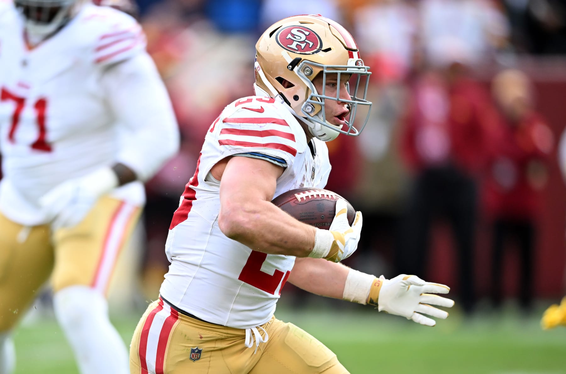 LANDOVER, MARYLAND - DECEMBER 31: Christian McCaffrey #23 of the San Francisco 49ers rushes the ball against the Washington Commanders at FedExField on December 31, 2023 in Landover, Maryland. (Photo by G Fiume/Getty Images)
