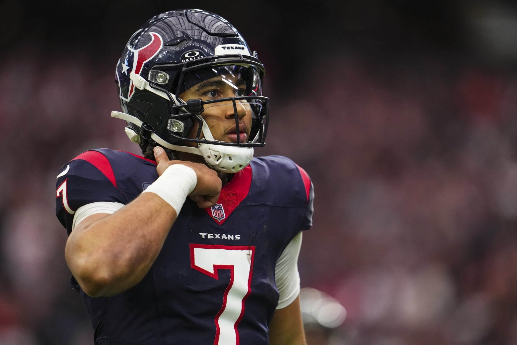 HOUSTON, TX - JANUARY 13: C.J. Stroud #7 of the Houston Texans looks on from the field during an NFL wild-card playoff football game against the Cleveland Browns at NRG Stadium on January 13, 2024 in Houston, Texas. (Photo by Cooper Neill/Getty Images)