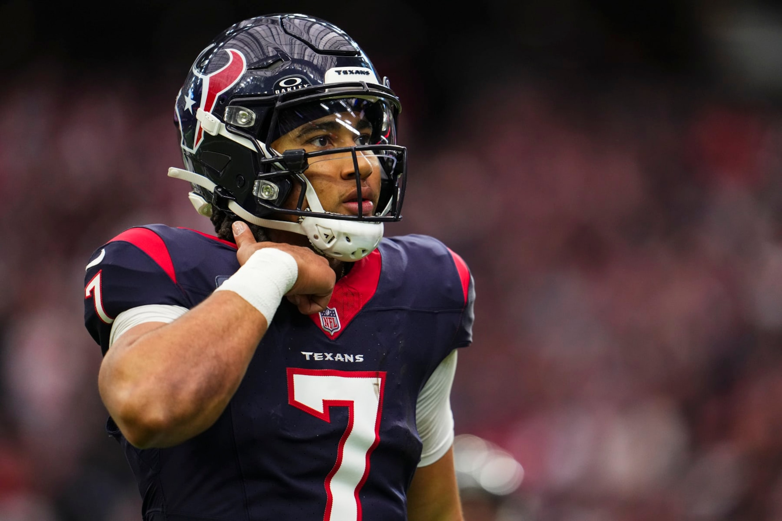 HOUSTON, TX - JANUARY 13: C.J. Stroud #7 of the Houston Texans looks on from the field during an NFL wild-card playoff football game against the Cleveland Browns at NRG Stadium on January 13, 2024 in Houston, Texas. (Photo by Cooper Neill/Getty Images)