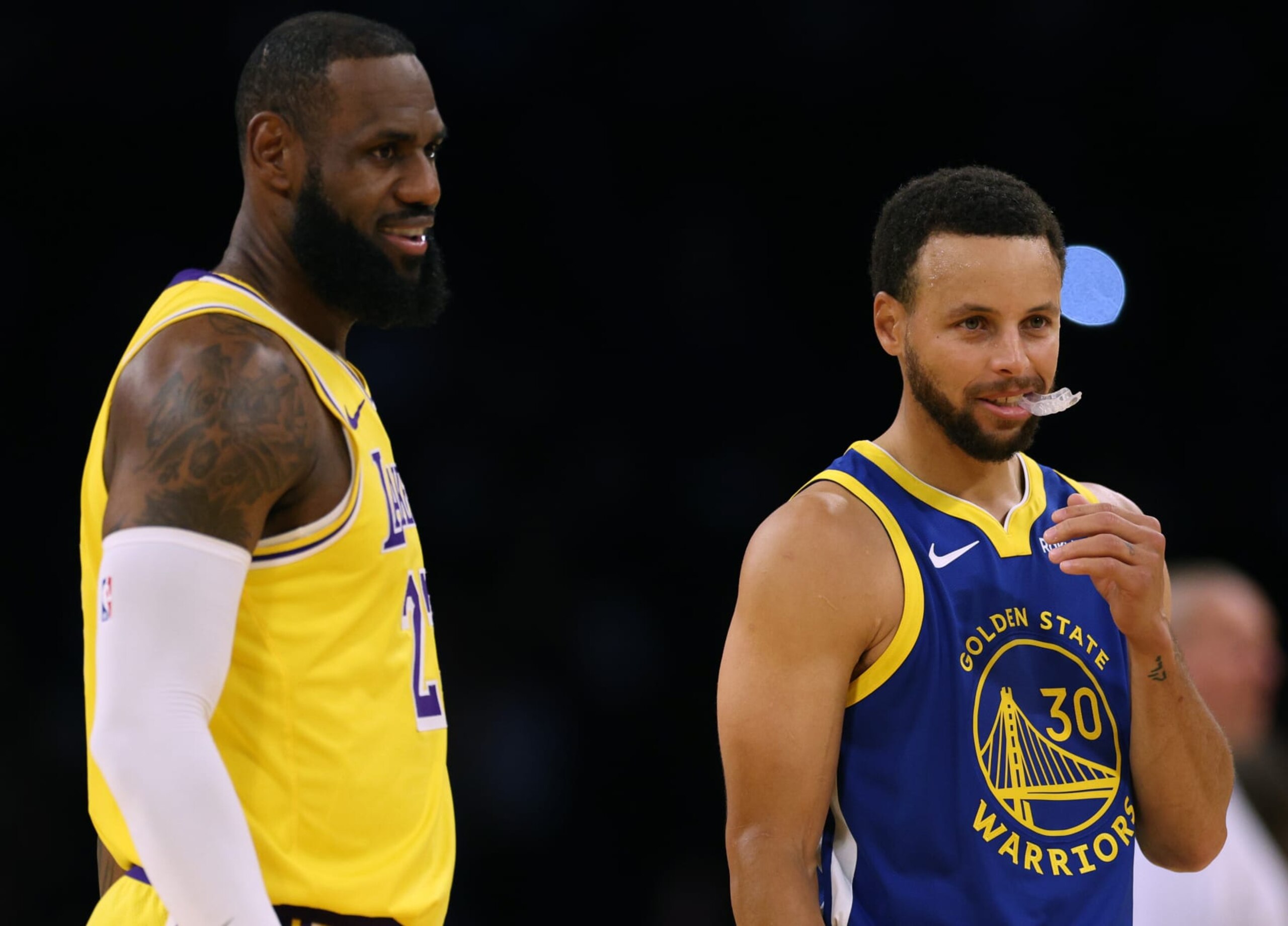 LOS ANGELES, CALIFORNIA - OCTOBER 13: LeBron James #23 of the Los Angeles Lakers and Stephen Curry #30 of the Golden State Warriors smile at center court before the start of a preseason game at Crypto.com Arena on October 13, 2023 in Los Angeles, California. (Photo by Harry How/Getty Images) NOTE TO USER: User expressly acknowledges and agrees that, by downloading and/or using this photograph, user is consenting to the terms and conditions of the Getty Images License Agreement. (Photo by Harry How/Getty Images)