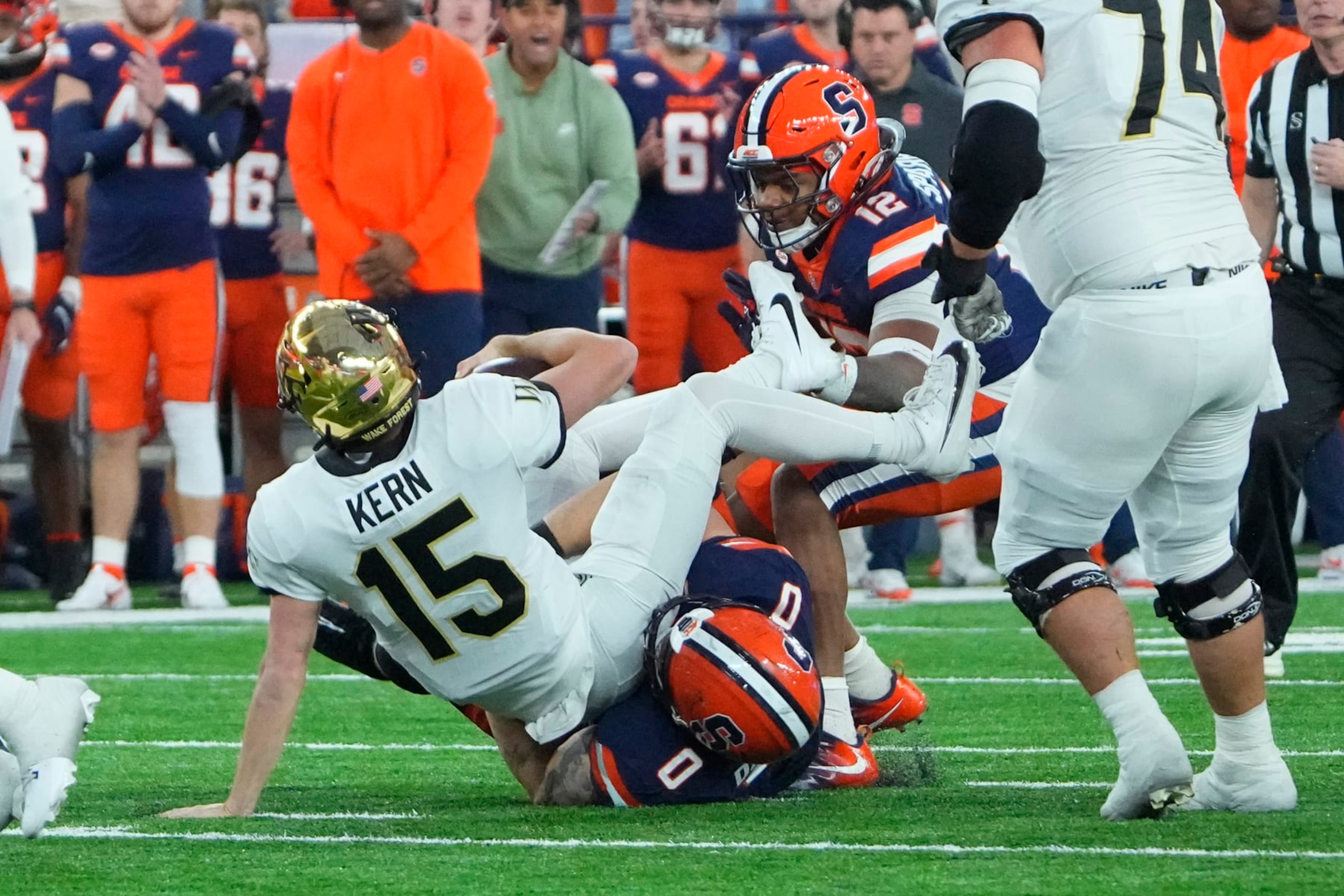 SYRACUSE, NY - NOVEMBER 25: Wake Forest Demon Deacons Quarterback Micahel Kern (15) is sacked by Syracuse Orange Defensive Lineman Kevon Darton (0) during the second half of the College Football Game between the Wake Forest Demon Deacons and the Syracuse Orange on November 25, 2023 at the JMA Wireless Dome in Syracuse, NY. (Photo by Gregory Fisher/Icon Sportswire via Getty Images)