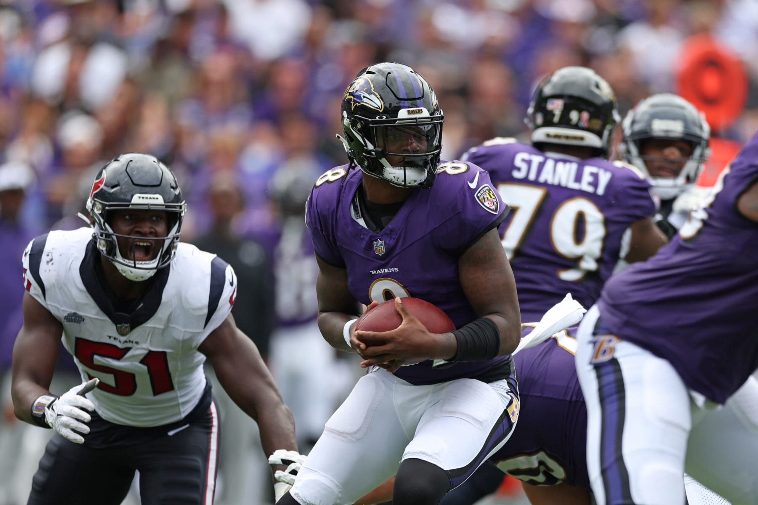 BALTIMORE, MARYLAND - SEPTEMBER 10:  Lamar Jackson #8 of the Baltimore Ravens carries the ball against the Houston Texans during the first half at M&T Bank Stadium on September 10, 2023 in Baltimore, Maryland. (Photo by Rob Carr/Getty Images)