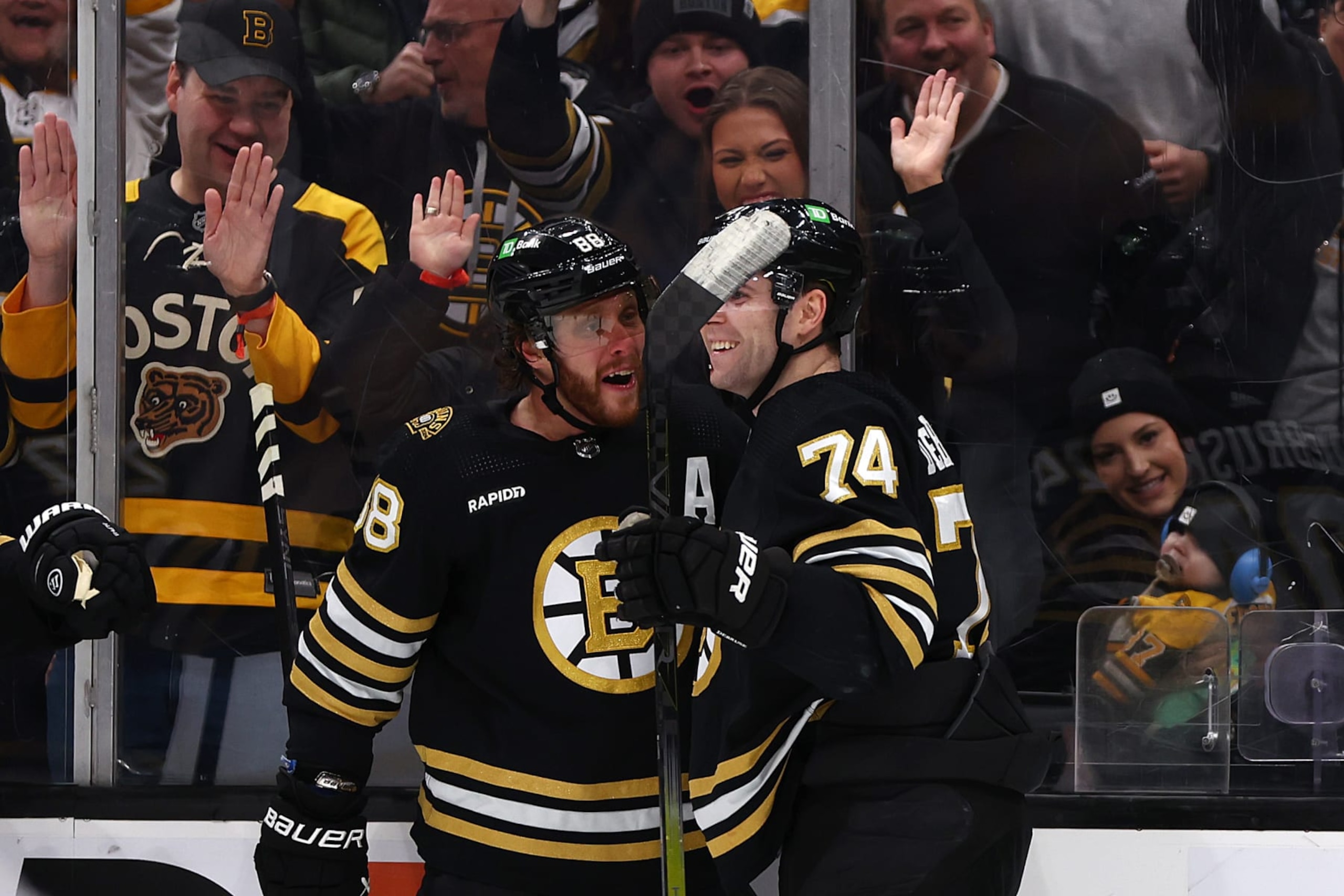 BOSTON, MASSACHUSETTS - JANUARY 18: David Pastrnak #88 of the Boston Bruins celebrates with Jake DeBrusk #74 after scoring against the Colorado Avalanche during the third period at TD Garden on January 18, 2024 in Boston, Massachusetts. The Bruins defeat the Avalanche 5-2.  (Photo by Maddie Meyer/Getty Images)