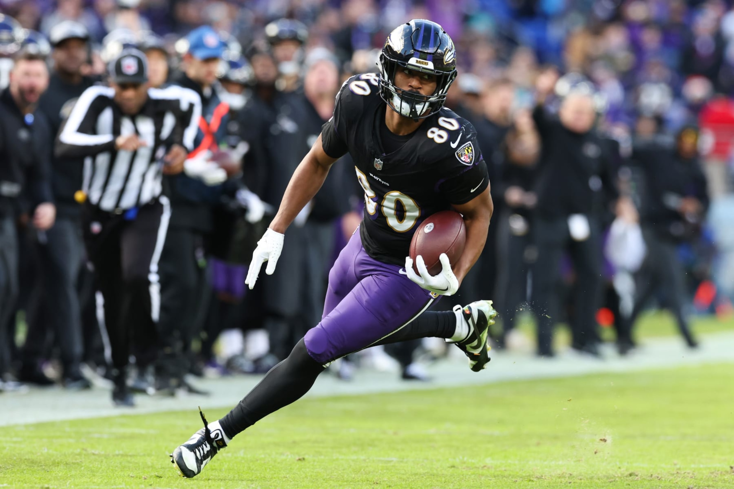 BALTIMORE, MARYLAND - DECEMBER 31: Isaiah Likely #80 of the Baltimore Ravens carries the ball for a touchdown against the Miami Dolphins during the second quarter of the game at M&T Bank Stadium on December 31, 2023 in Baltimore, Maryland. (Photo by Todd Olszewski/Getty Images)