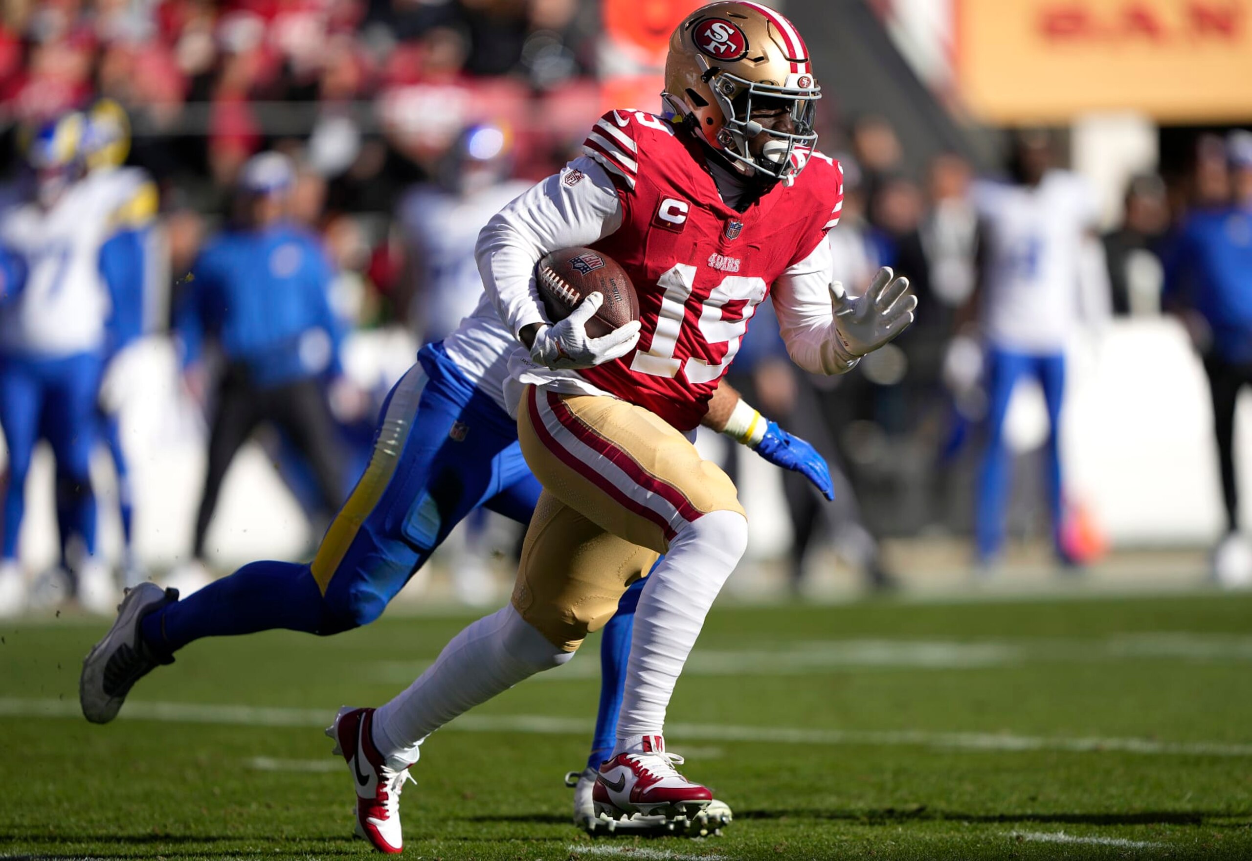 SANTA CLARA, CALIFORNIA - JANUARY 07: Deebo Samuel #19 of the San Francisco 49ers runs with the ball after catching a pass against the Los Angeles Rams during the first quarter of an NFL football game at Levi's Stadium on January 07, 2024 in Santa Clara, California. (Photo by Thearon W. Henderson/Getty Images) SANTA CLARA, CALIFORNIA - JANUARY 07: Deebo Samuel #19 of the San Francisco 49ers runs with the ball after catching a pass against the Los Angeles Rams during the first quarter of an NFL football game at Levi's Stadium on January 07, 2024 in Santa Clara, California. (Photo by Thearon W. Henderson/Getty Images)