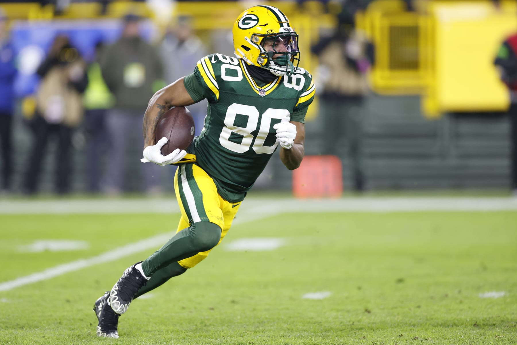 GREEN BAY, WISCONSIN - JANUARY 07: Bo Melton #80 of the Green Bay Packers runs the ball during the third quarter in the game against the Chicago Bears at Lambeau Field on January 07, 2024 in Green Bay, Wisconsin. (Photo by John Fisher/Getty Images)