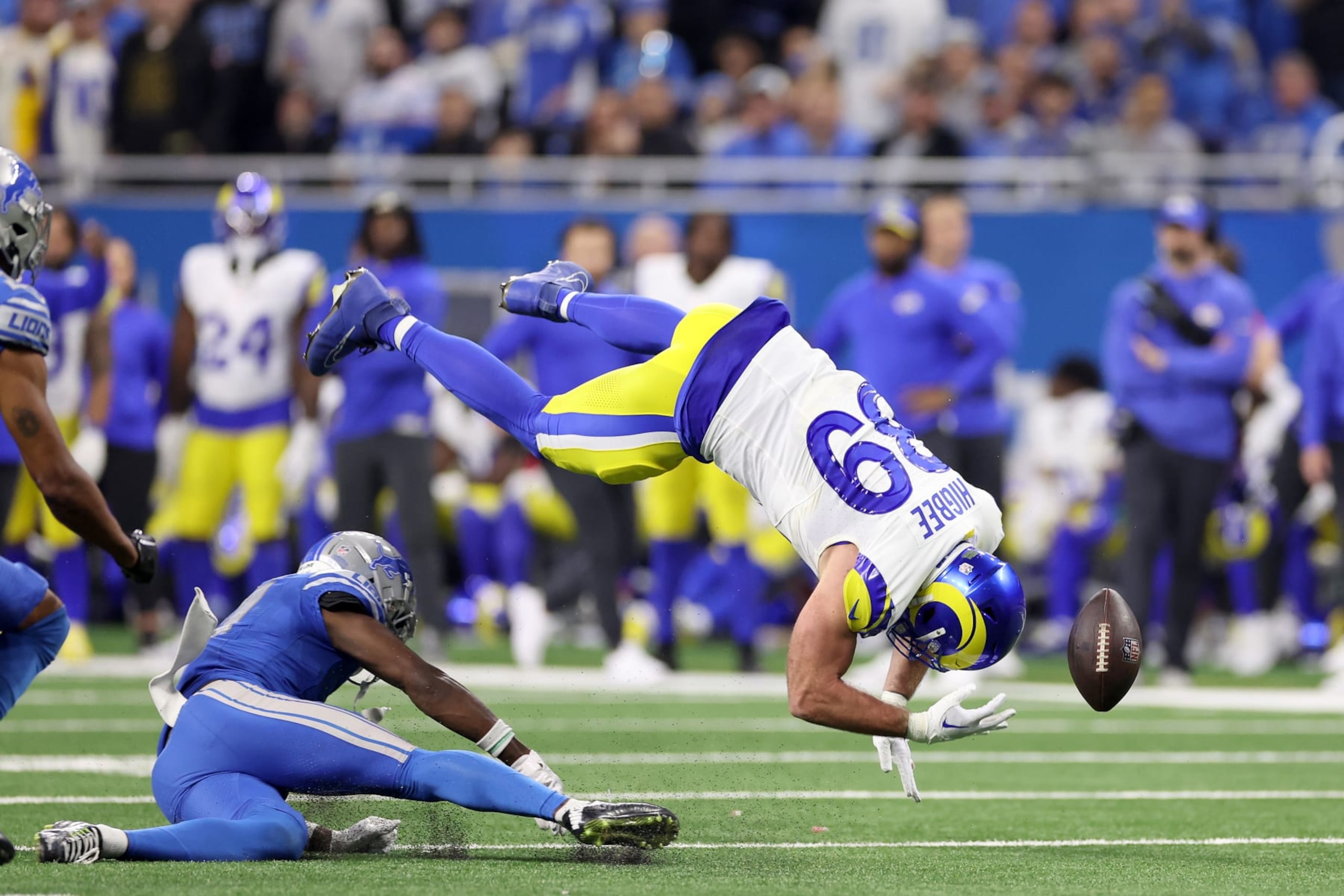 DETROIT, MICHIGAN - JANUARY 14: Tyler Higbee #89 of the Los Angeles Rams is hit by Kerby Joseph #31 of the Detroit Lions during the second half in the NFC Wild Card Playoffs at Ford Field on January 14, 2024 in Detroit, Michigan. (Photo by Gregory Shamus/Getty Images)