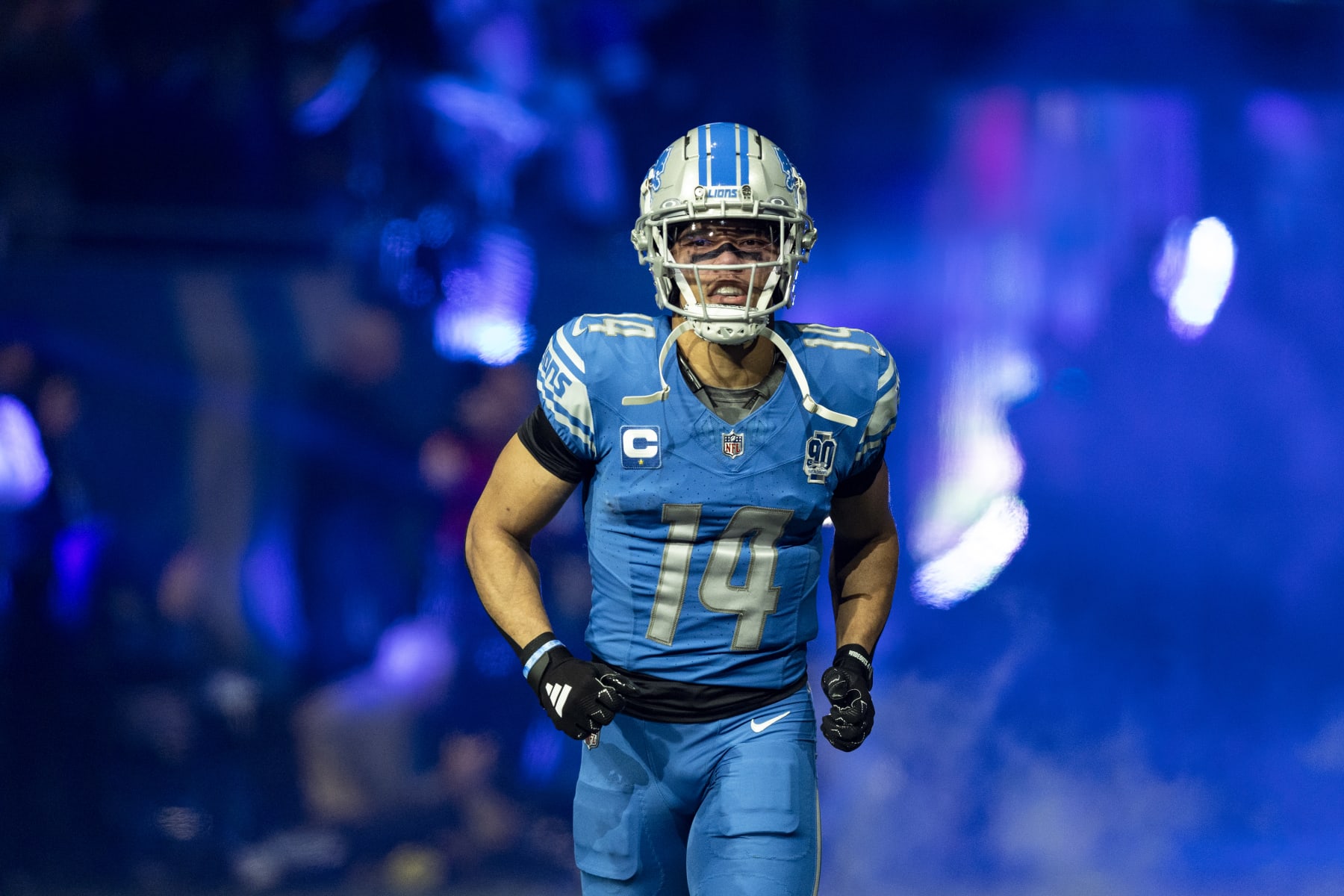 DETROIT, MICHIGAN - JANUARY 14: Amon-Ra St. Brown #14 of the Detroit Lions runs onto the field before the game against the Los Angeles Rams at Ford Field on January 14, 2024 in Detroit, Michigan. The Lions beat the Rams 24-23. (Photo by Lauren Leigh Bacho/Getty Images)