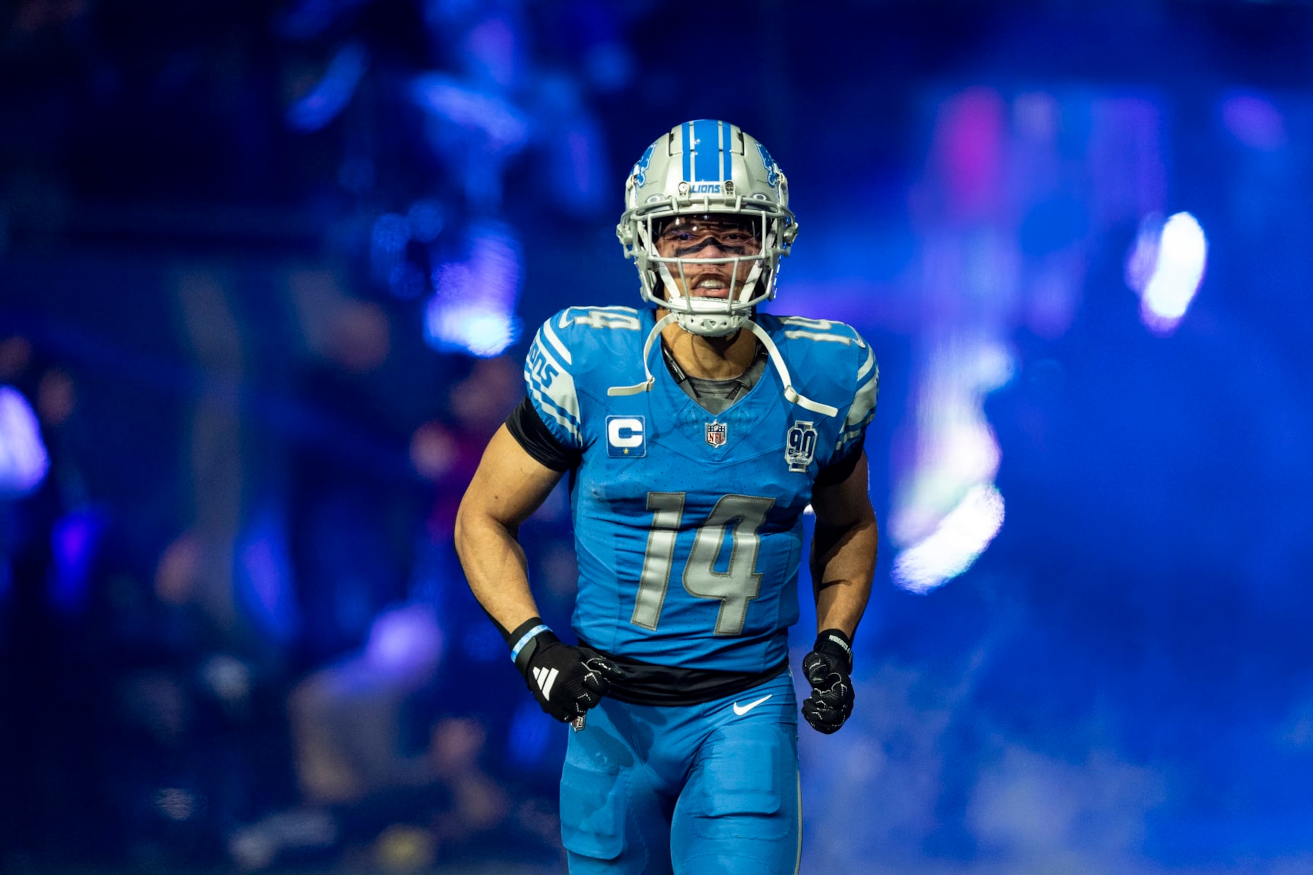 DETROIT, MICHIGAN - JANUARY 14: Amon-Ra St. Brown #14 of the Detroit Lions runs onto the field before the game against the Los Angeles Rams at Ford Field on January 14, 2024 in Detroit, Michigan. The Lions beat the Rams 24-23. (Photo by Lauren Leigh Bacho/Getty Images)