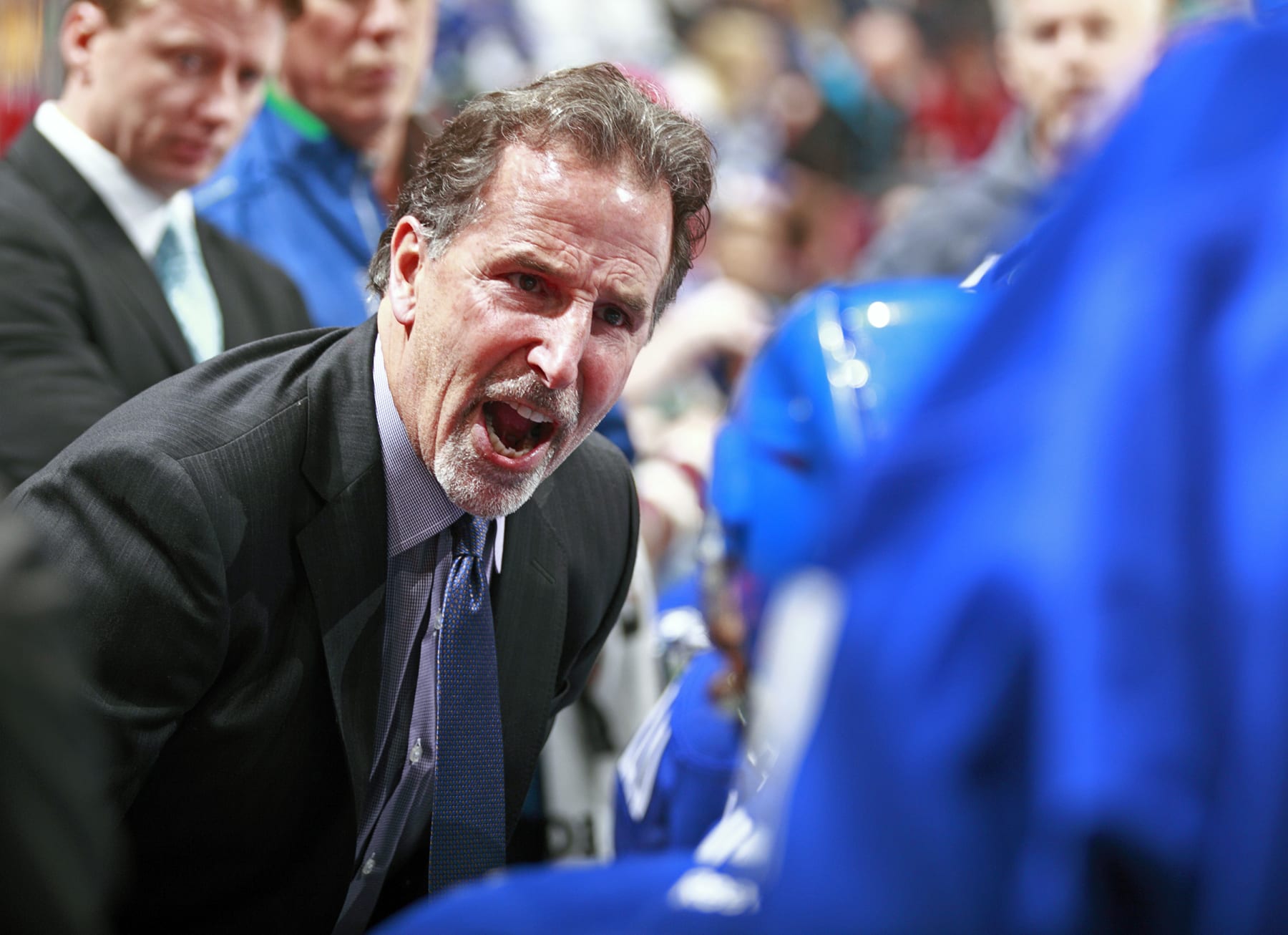 VANCOUVER, BC - DECEMBER 14:   Head coach John Tortorella of the Vancouver Canucks yells at his players during a timeout in their NHL game against the Boston Bruins at Rogers Arena December 14, 2013 in Vancouver, British Columbia, Canada. Vancouver won 6-2.  (Photo by Jeff Vinnick/NHLI via Getty Images)