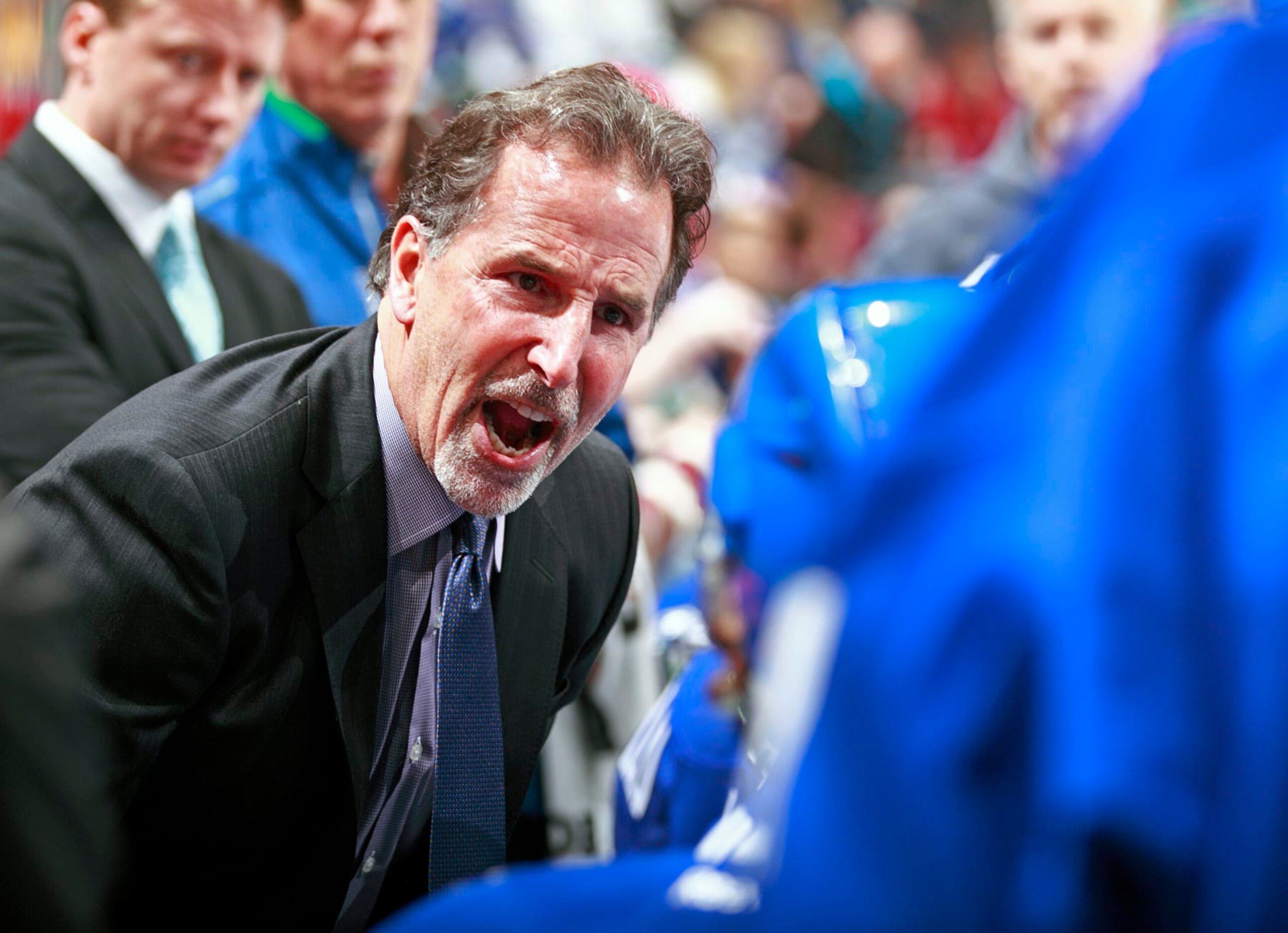 VANCOUVER, BC - DECEMBER 14:   Head coach John Tortorella of the Vancouver Canucks yells at his players during a timeout in their NHL game against the Boston Bruins at Rogers Arena December 14, 2013 in Vancouver, British Columbia, Canada. Vancouver won 6-2.  (Photo by Jeff Vinnick/NHLI via Getty Images)