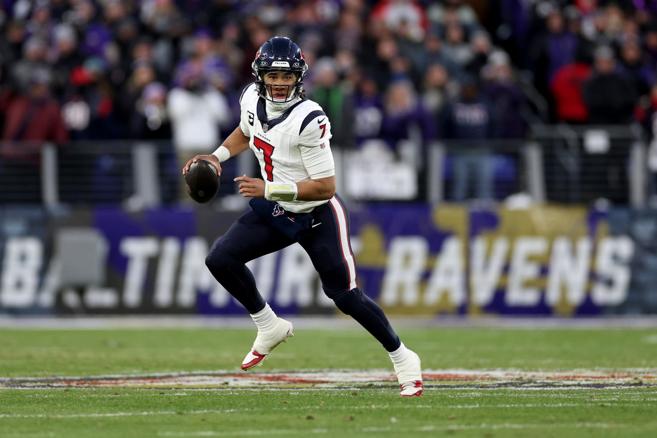 BALTIMORE, MARYLAND - JANUARY 20: C.J. Stroud #7 of the Houston Texans scrambles against the Baltimore Ravens during the first quarter in the AFC Divisional Playoff game at M&T Bank Stadium on January 20, 2024 in Baltimore, Maryland. (Photo by Patrick Smith/Getty Images)