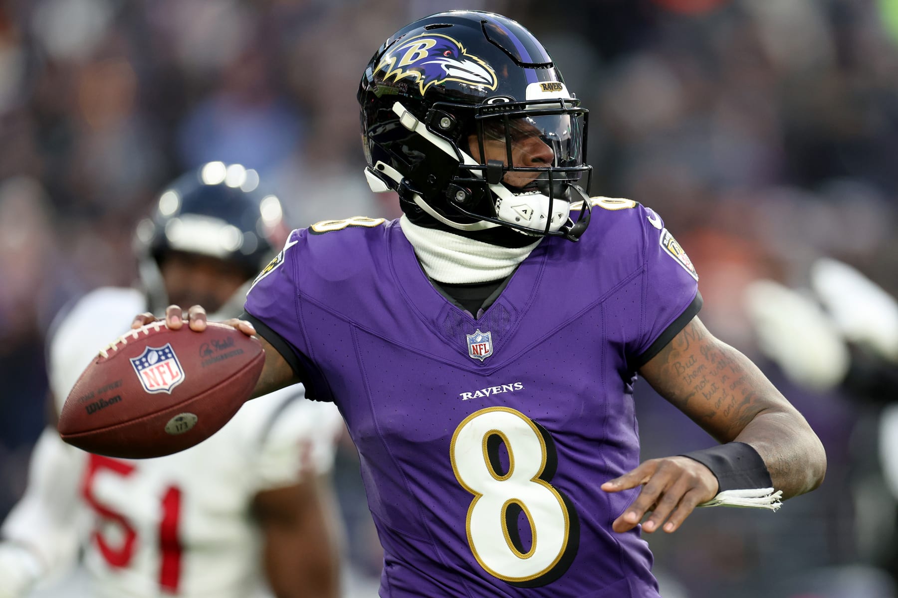BALTIMORE, MARYLAND - JANUARY 20: Lamar Jackson #8 of the Baltimore Ravens looks to throw a pass against the Houston Texans during the first quarter in the AFC Divisional Playoff game at M&T Bank Stadium on January 20, 2024 in Baltimore, Maryland. (Photo by Rob Carr/Getty Images)