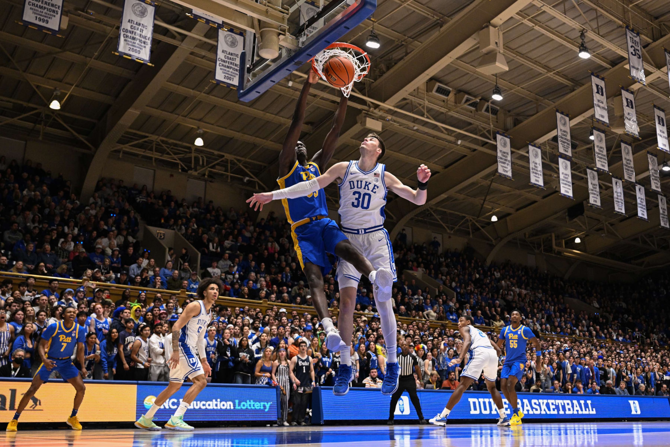 DURHAM, NORTH CAROLINA - JANUARY 20: Federiko Federiko #33 of the Pittsburgh Panthers dunks over Kyle Filipowski #30 of the Duke Blue Devilsduring the first half of the game at Cameron Indoor Stadium on January 20, 2024 in Durham, North Carolina. (Photo by Grant Halverson/Getty Images)