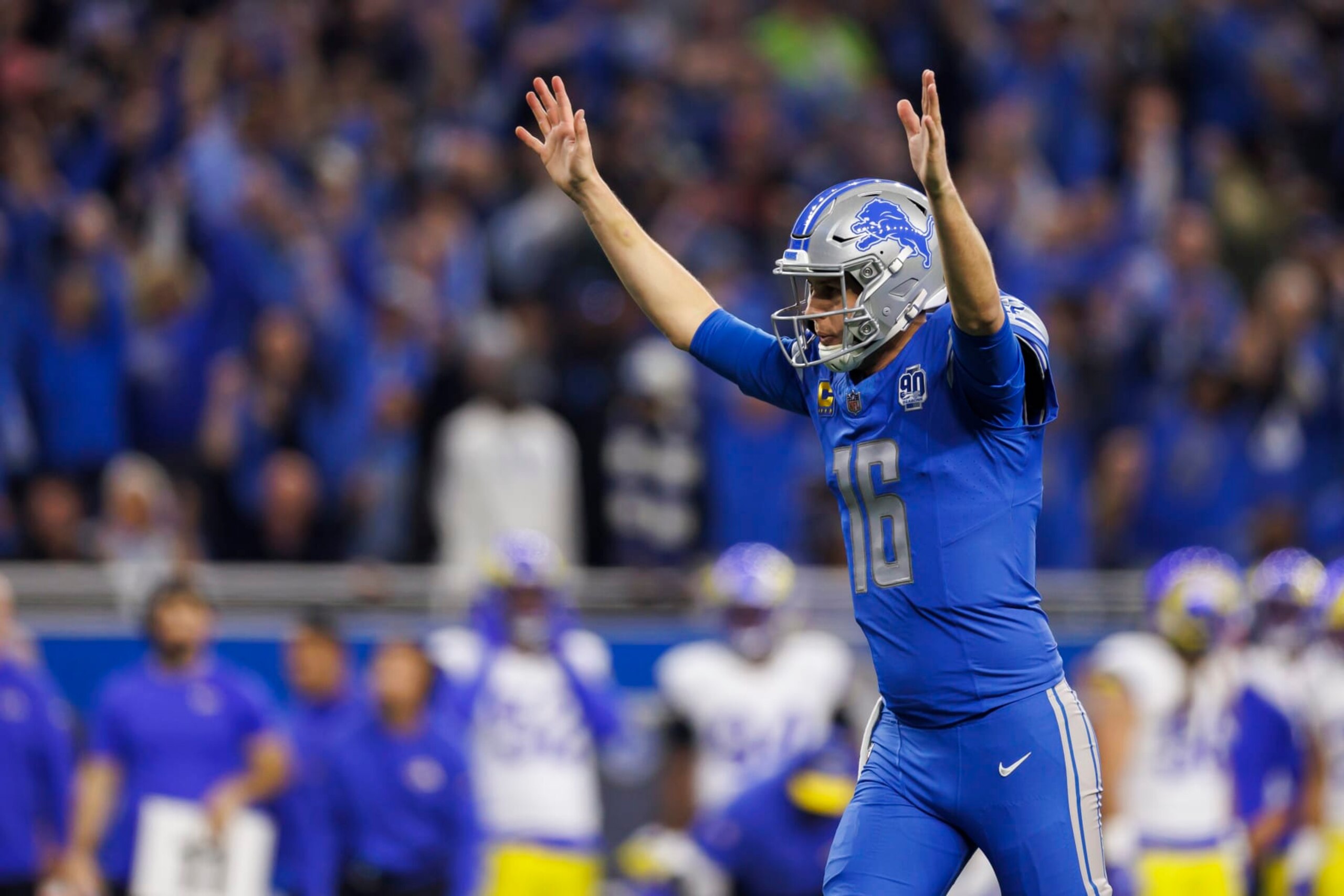 DETROIT, MICHIGAN - JANUARY 14: Jared Goff #16 of the Detroit Lions celebrates after the team scored a touchdown during an NFC Wild Card Playoff football game against the Los Angeles Rams at Ford Field on January 14, 2024 in Detroit, Michigan. (Photo by Ryan Kang/Getty Images)