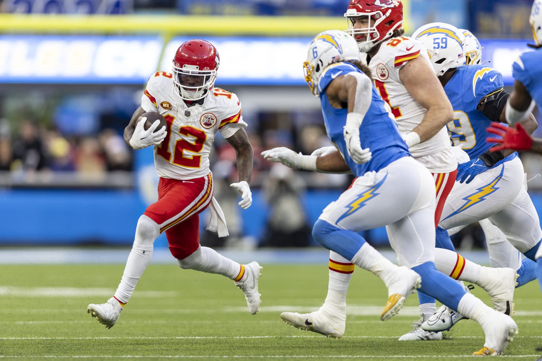 INGLEWOOD, CALIFORNIA - JANUARY 07: Mecole Hardman Jr. #12 of the Kansas City Chiefs runs with the ball during an NFL football game between the Los Angeles Chargers and the Kansas City Chiefs at SoFi Stadium on January 07, 2024 in Inglewood, California. (Photo by Michael Owens/Getty Images)