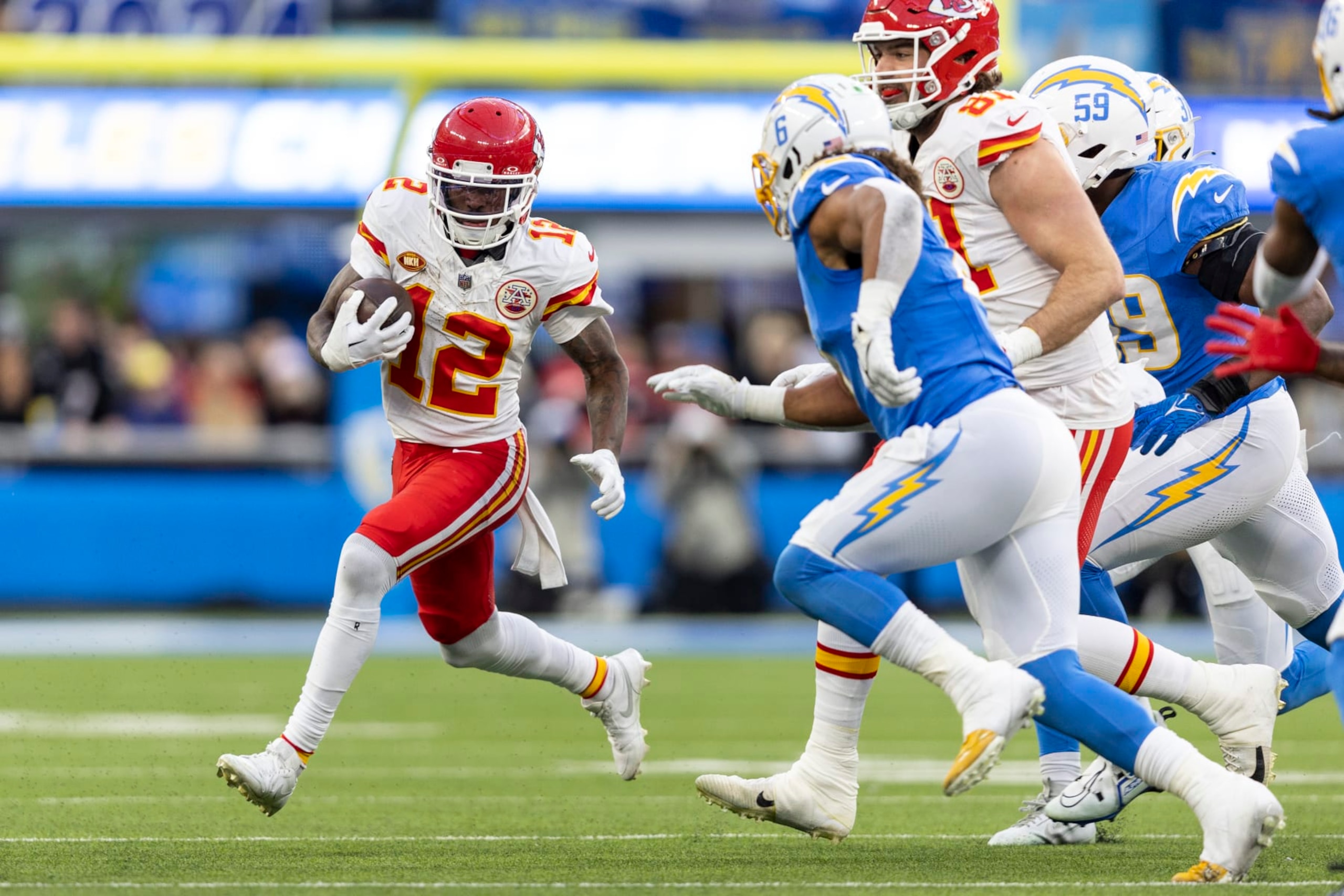 INGLEWOOD, CALIFORNIA - JANUARY 07: Mecole Hardman Jr. #12 of the Kansas City Chiefs runs with the ball during an NFL football game between the Los Angeles Chargers and the Kansas City Chiefs at SoFi Stadium on January 07, 2024 in Inglewood, California. (Photo by Michael Owens/Getty Images)