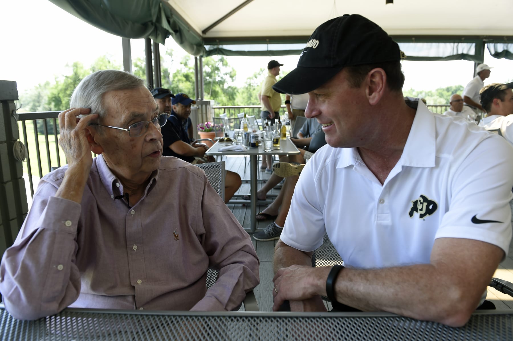 GREELEY, CO - JULY 2: Sports announcer Larry Zimmer talks with CU Athletic Director Rick George, right, before meeting with members of the press at the Greeley Country Club in Greeley, Colorado on July 2015.  Zimmer, the voice of University of Colorado football who has spanned five decades with the program, announced that he will return for his 42nd and final season working on the schools broadcasts on KOA-Radio.  Zimmer, 79, missed the last 6 games of the 2014 season after suffering complications from a fall in his home on October 4, 2015.  After he was hospitalized for the better part of 5 months he continues to make what his doctors feel will be a full recovery. (Photo By Helen H. Richardson/ The Denver Post)