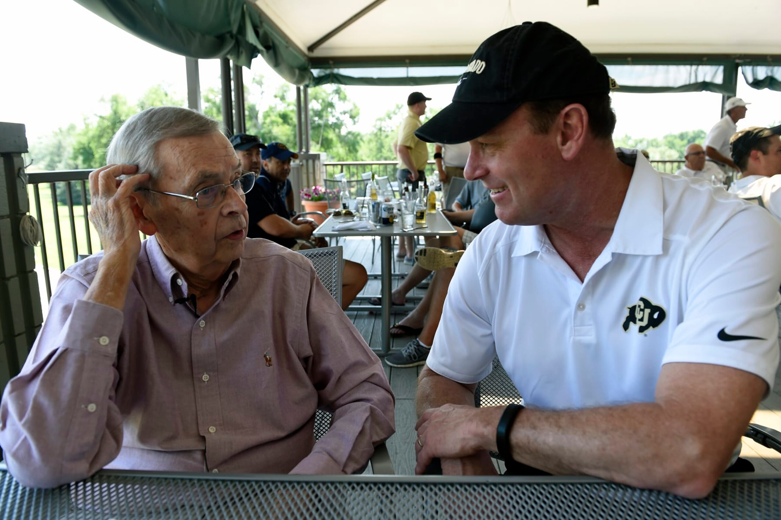 GREELEY, CO - JULY 2: Sports announcer Larry Zimmer talks with CU Athletic Director Rick George, right, before meeting with members of the press at the Greeley Country Club in Greeley, Colorado on July 2015. Zimmer, the voice of University of Colorado football who has spanned five decades with the program, announced that he will return for his 42nd and final season working on the schools broadcasts on KOA-Radio. Zimmer, 79, missed the last 6 games of the 2014 season after suffering complications from a fall in his home on October 4, 2015. After he was hospitalized for the better part of 5 months he continues to make what his doctors feel will be a full recovery. (Photo By Helen H. Richardson/ The Denver Post) GREELEY, CO - JULY 2: Sports announcer Larry Zimmer talks with CU Athletic Director Rick George, right, before meeting with members of the press at the Greeley Country Club in Greeley, Colorado on July 2015. Zimmer, the voice of University of Colorado football who has spanned five decades with the program, announced that he will return for his 42nd and final season working on the schools broadcasts on KOA-Radio. Zimmer, 79, missed the last 6 games of the 2014 season after suffering complications from a fall in his home on October 4, 2015. After he was hospitalized for the better part of 5 months he continues to make what his doctors feel will be a full recovery. (Photo By Helen H. Richardson/ The Denver Post)