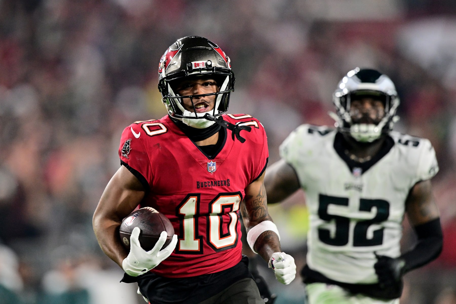 TAMPA, FLORIDA - JANUARY 15: Trey Palmer #10 of the Tampa Bay Buccaneers runs the ball to score a 56 yard touchdown against the Philadelphia Eagles during the third quarter in the NFC Wild Card Playoffs at Raymond James Stadium on January 15, 2024 in Tampa, Florida. (Photo by Julio Aguilar/Getty Images)