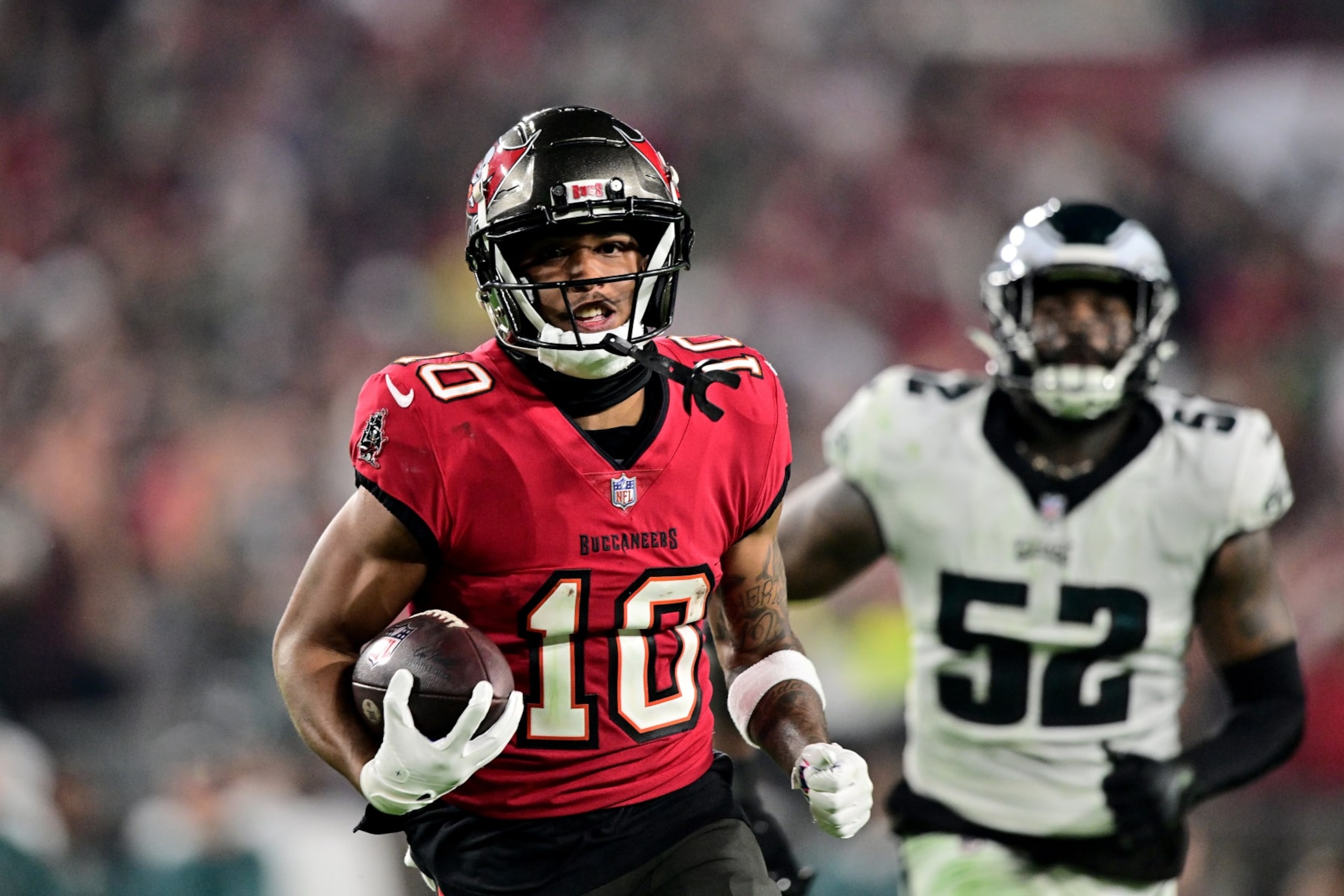 TAMPA, FLORIDA - JANUARY 15: Trey Palmer #10 of the Tampa Bay Buccaneers runs the ball to score a 56 yard touchdown against the Philadelphia Eagles during the third quarter in the NFC Wild Card Playoffs at Raymond James Stadium on January 15, 2024 in Tampa, Florida. (Photo by Julio Aguilar/Getty Images)