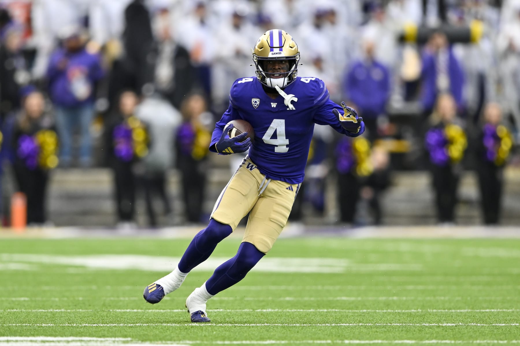 SEATTLE, WASHINGTON - NOVEMBER 11: Germie Bernard #4 of the Washington Huskies runs the ball during the fourth quarter against the Utah Utes at Husky Stadium on November 11, 2023 in Seattle, Washington. The Washington Huskies won 35-28. (Photo by Alika Jenner/Getty Images)