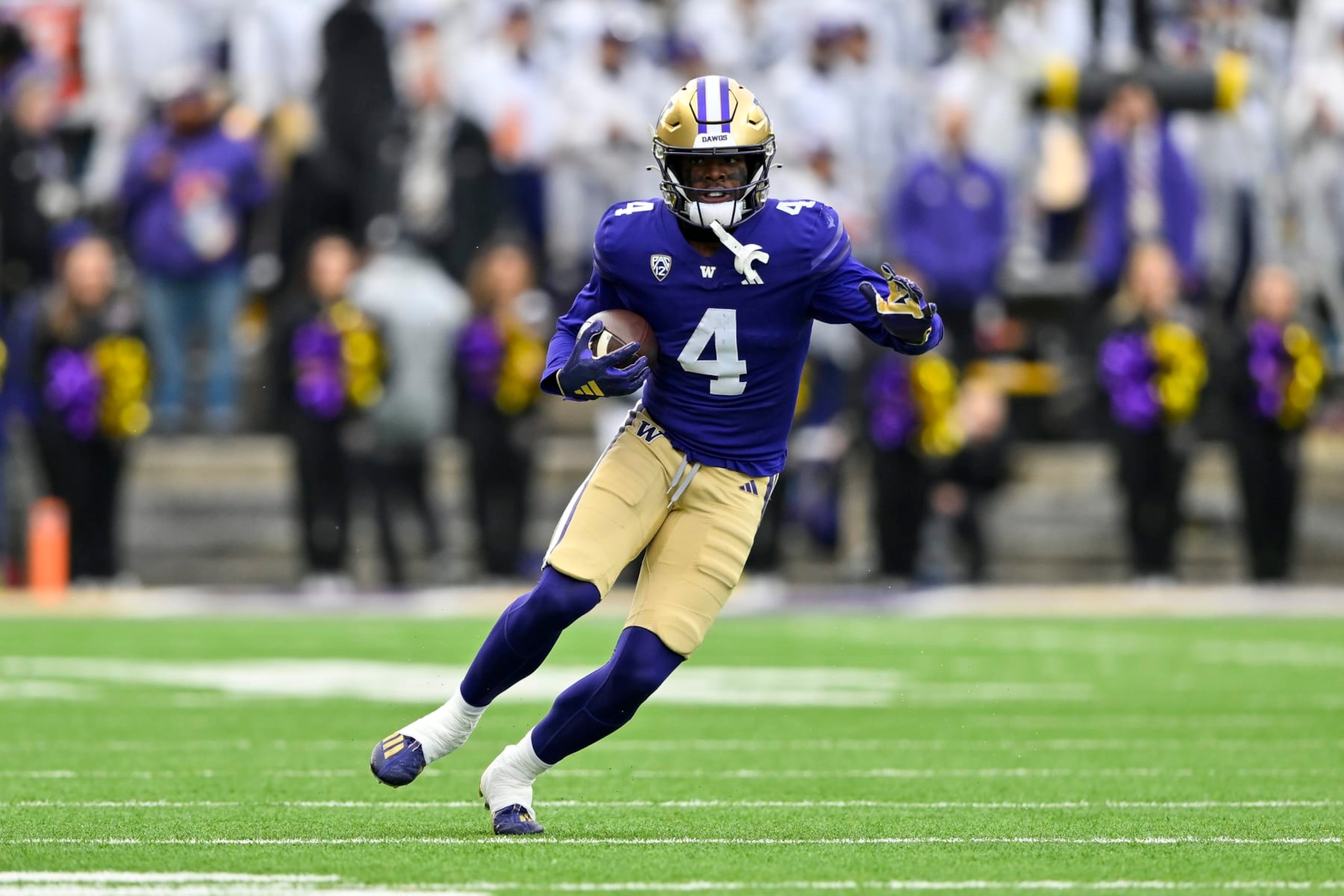 SEATTLE, WASHINGTON - NOVEMBER 11: Germie Bernard #4 of the Washington Huskies runs the ball during the fourth quarter against the Utah Utes at Husky Stadium on November 11, 2023 in Seattle, Washington. The Washington Huskies won 35-28. (Photo by Alika Jenner/Getty Images)